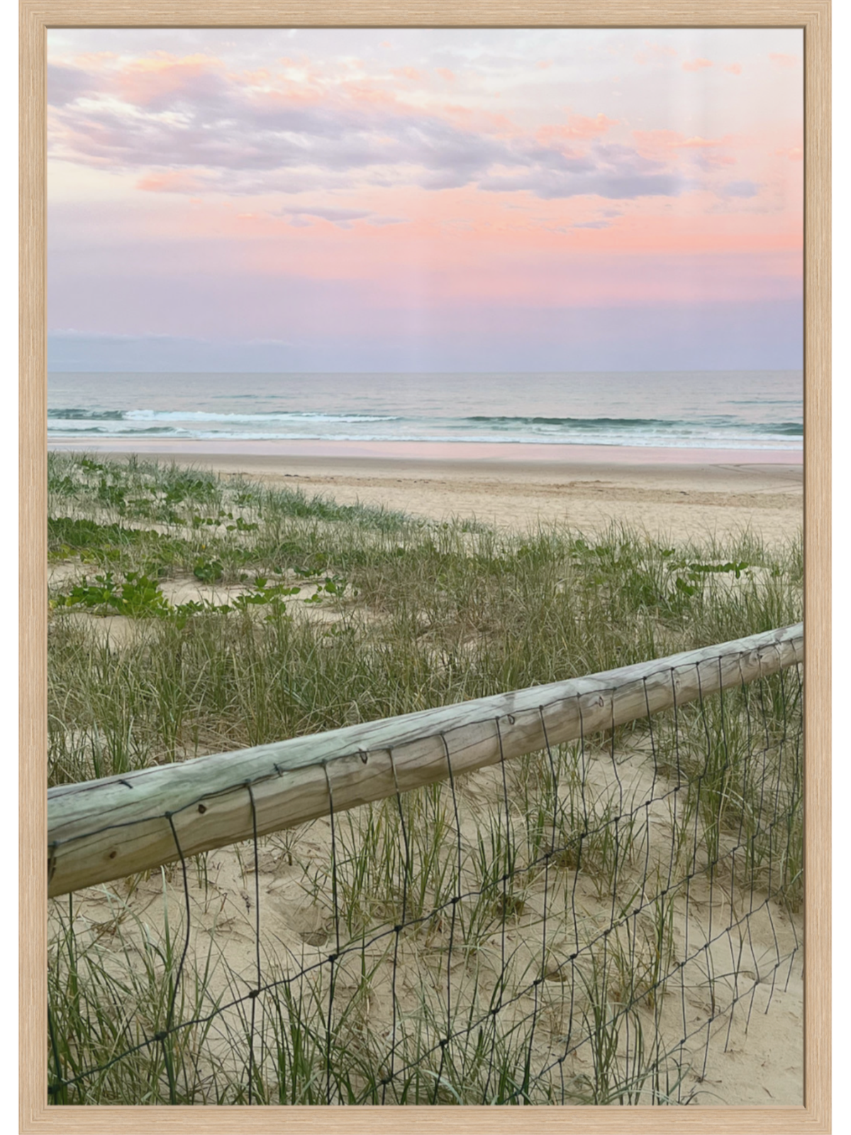 Pastel sunset beach scene wall art in light wood frame with ocean view