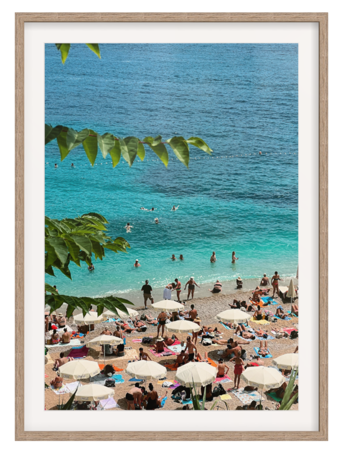 Beach scene with people, umbrellas, and turquoise water framed by a wooden border. Hazel frame with border