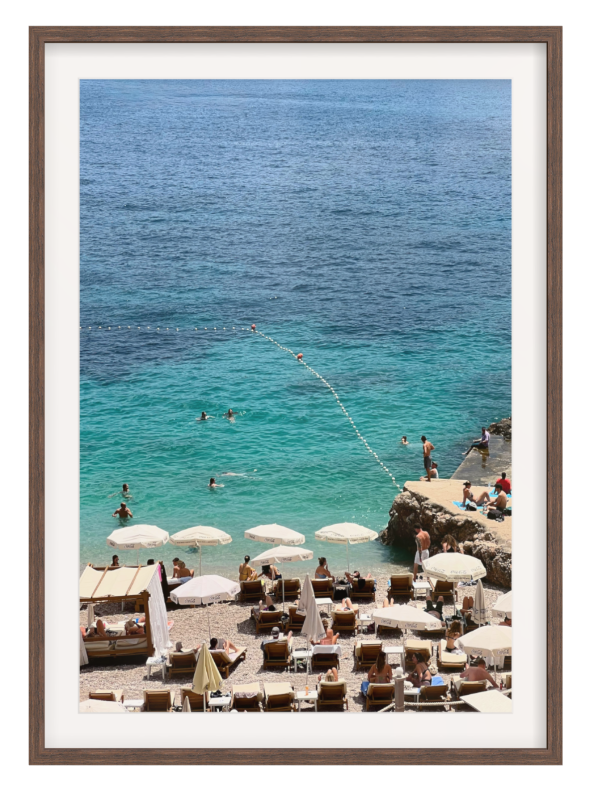 Beach scene with people swimming and sunbathing, framed artwork. Banje beach chocolate frame with border