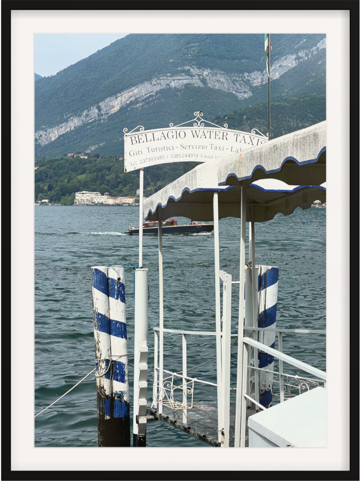 Close-up of weathered blue and white striped pilings on Bellagio jetty art print in black frame