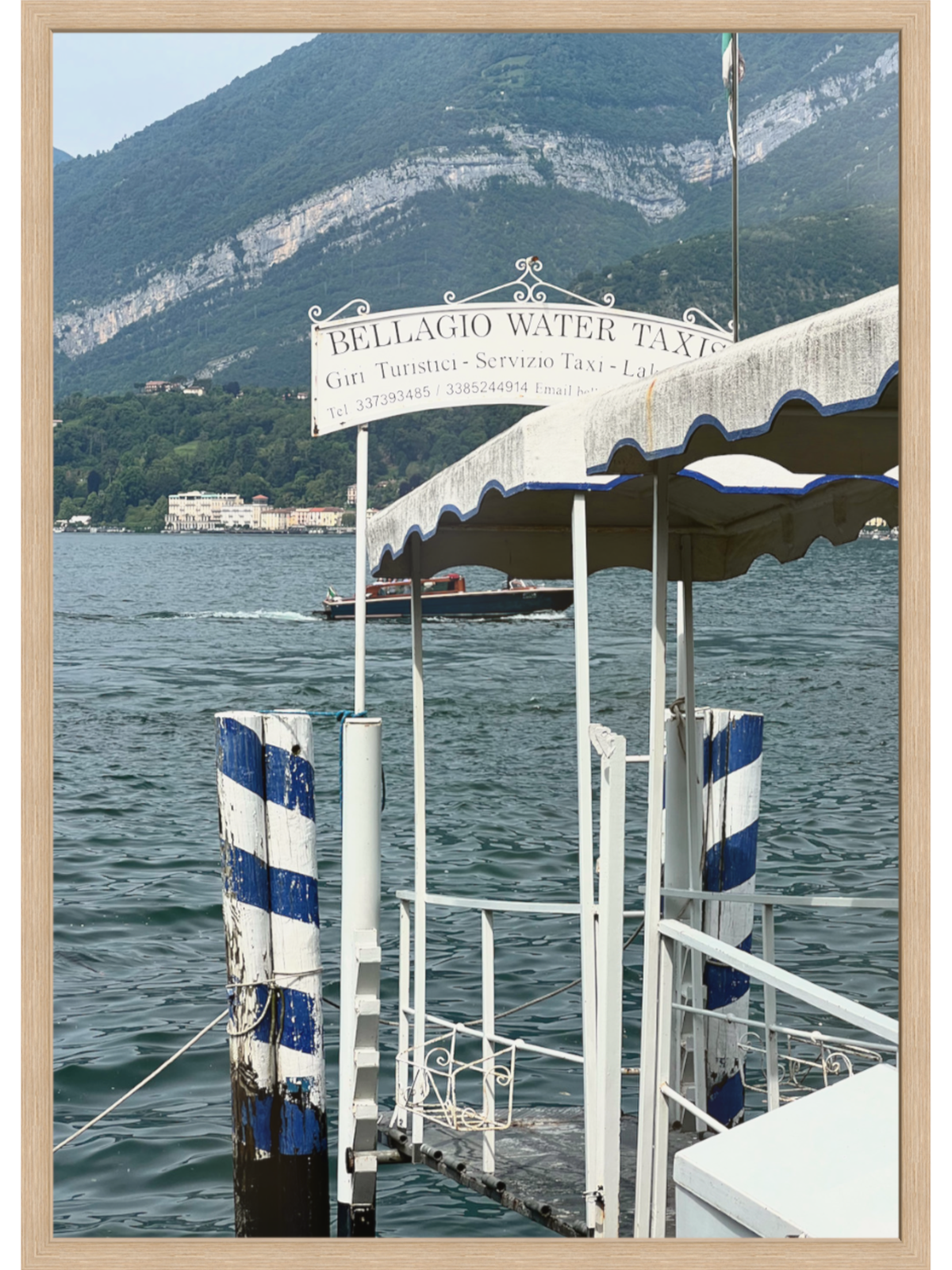 Bellagio Water Taxi scene art print featuring scalloped awning and lake view in light wood frame