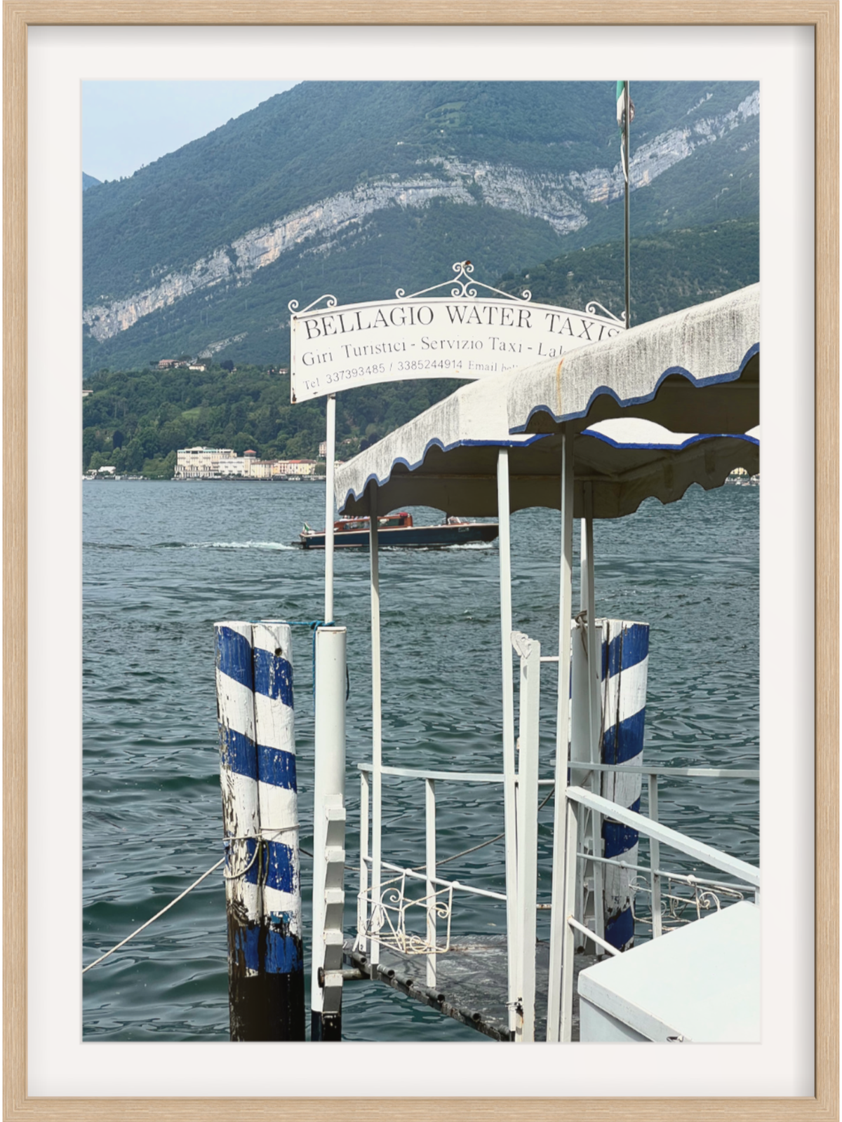 Bellagio dock scene art print with clear daylight view of Lake Como mountains in light wood frame