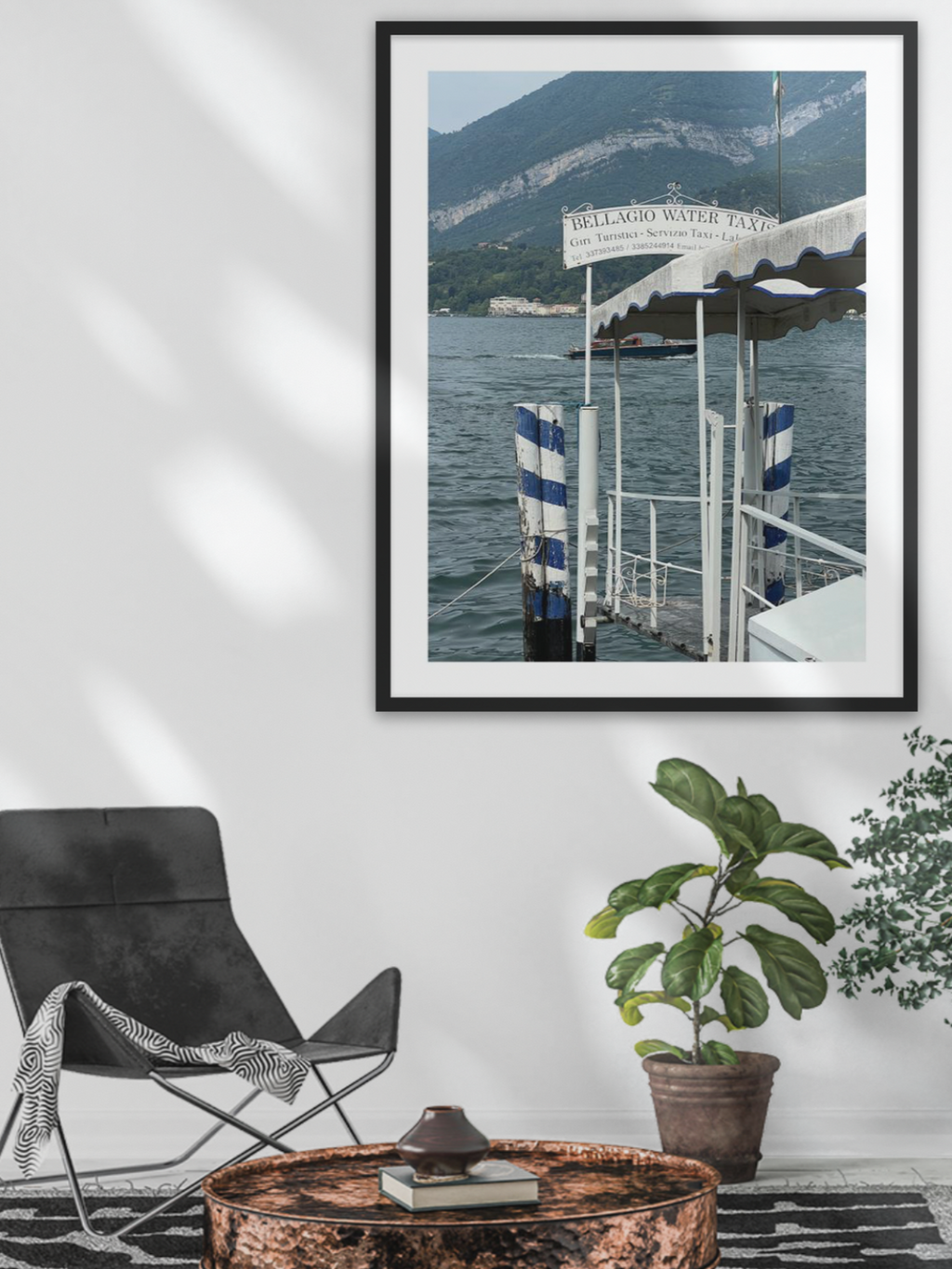 Bellagio waterfront wall art in black frame styled above copper coffee table for coastal home decor