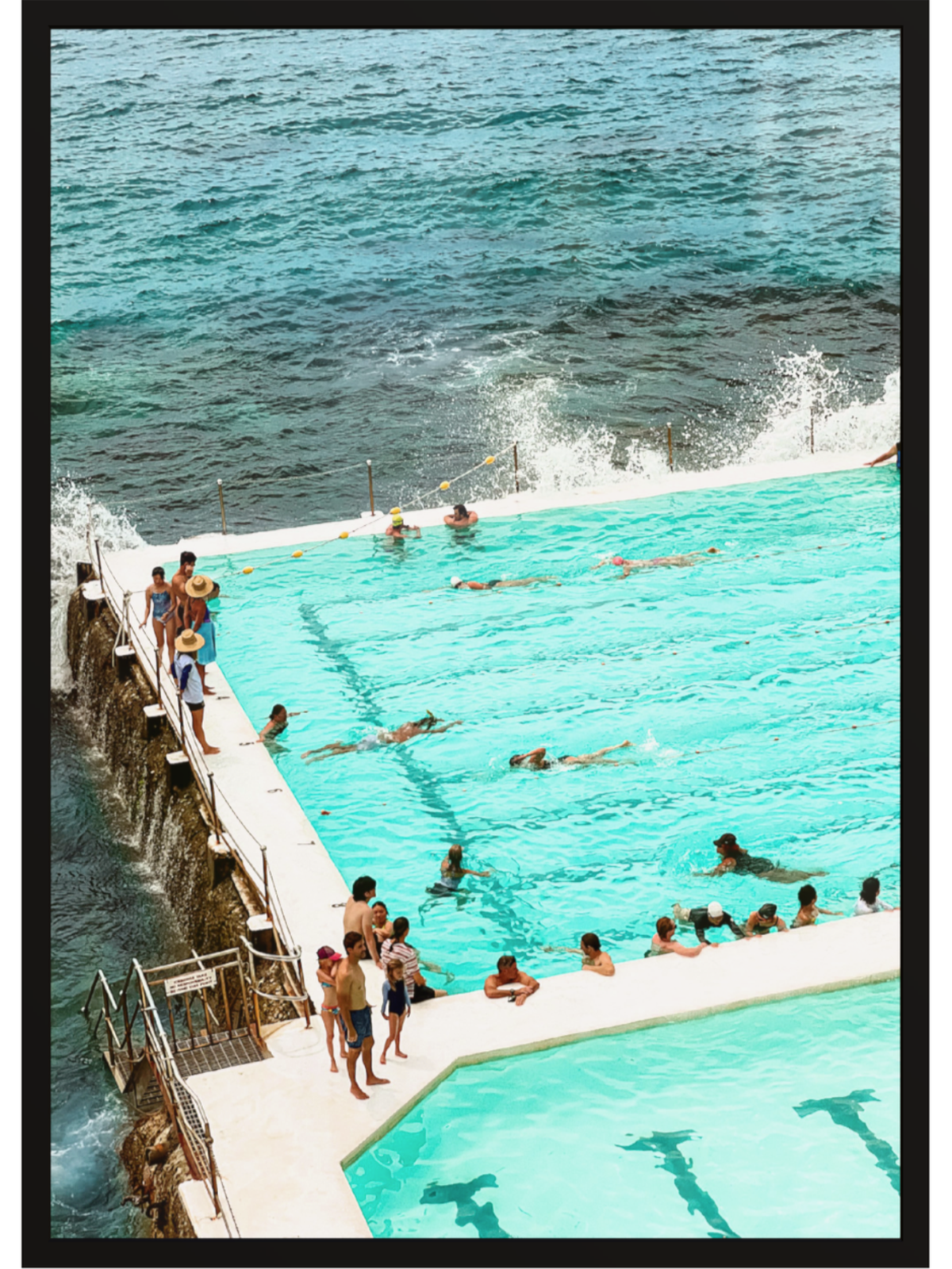 People swimming in a pool with ocean view