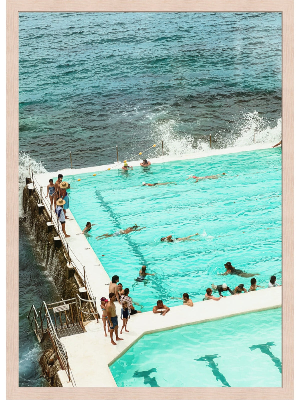 People swimming in a pool with ocean view