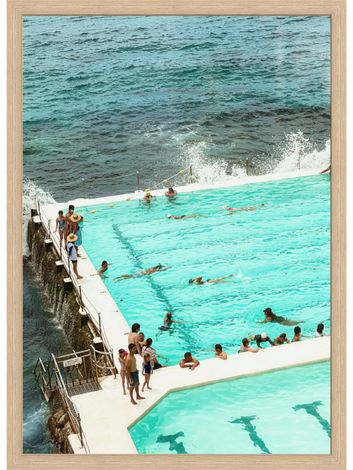 People swimming in a pool with ocean view