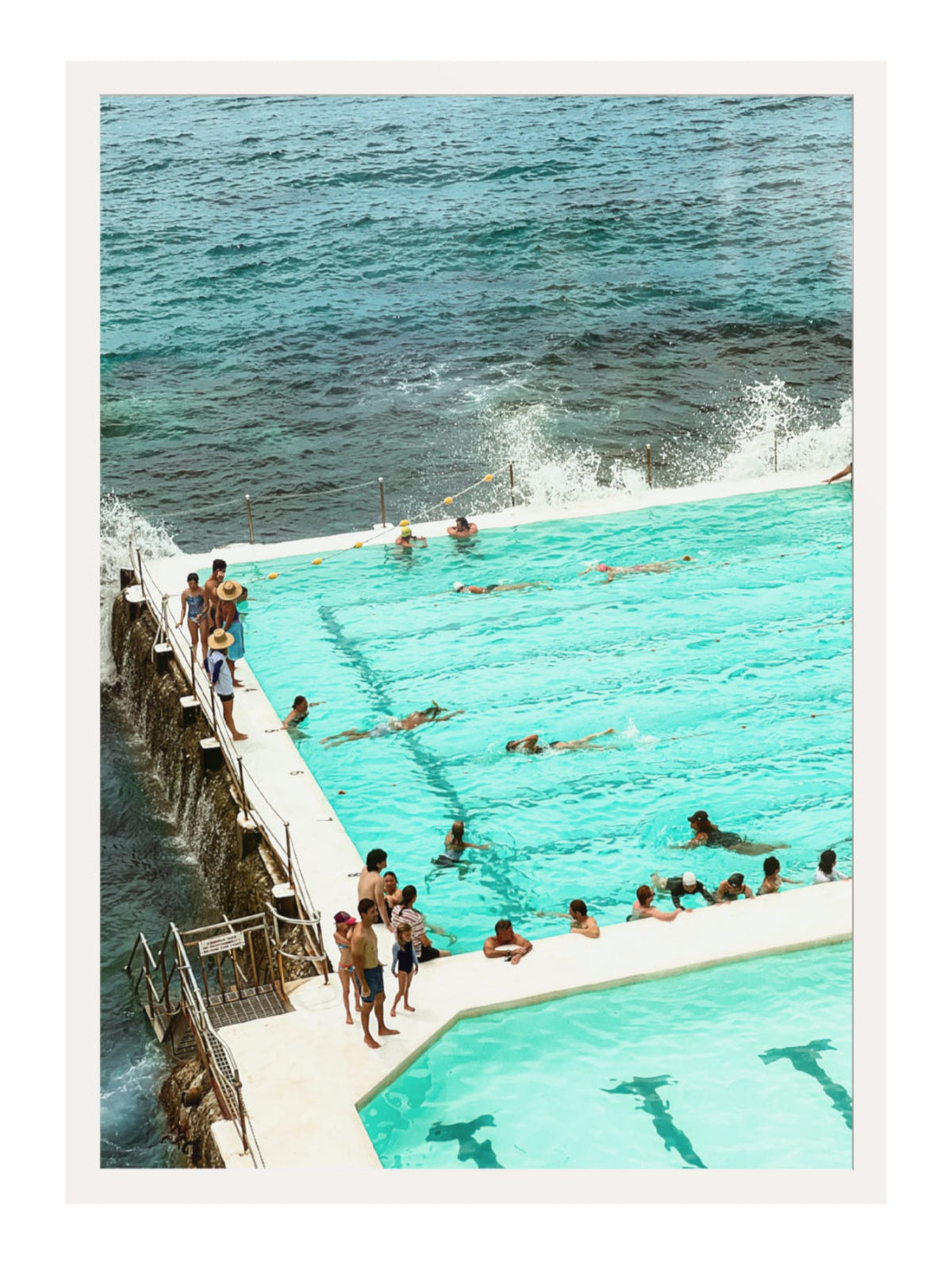 People swimming in a pool with ocean view
