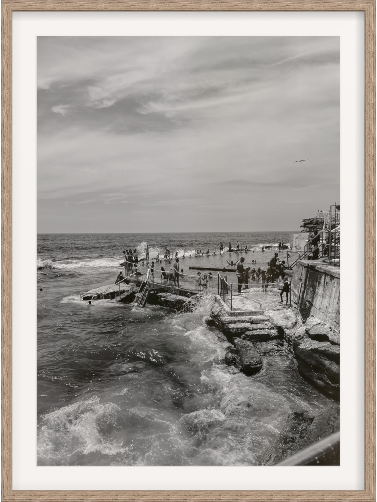 Bronte III B&W ocean bath scene with light wood frame and white mat