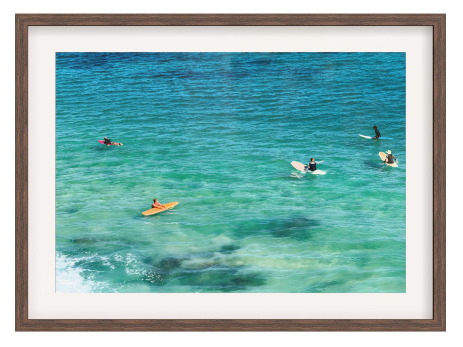 People on surfboards in clear blue water with a brown frame.