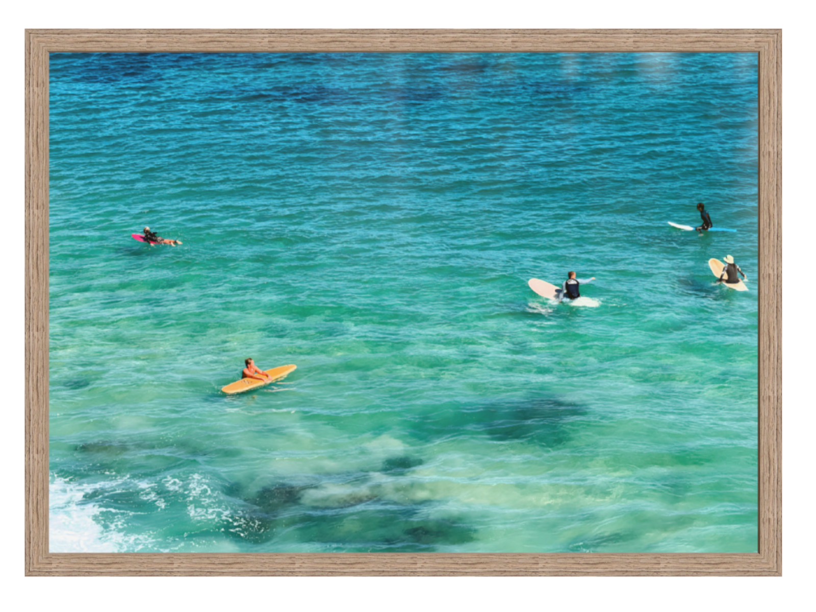 People on surfboards in a body of water with a wooden frame.