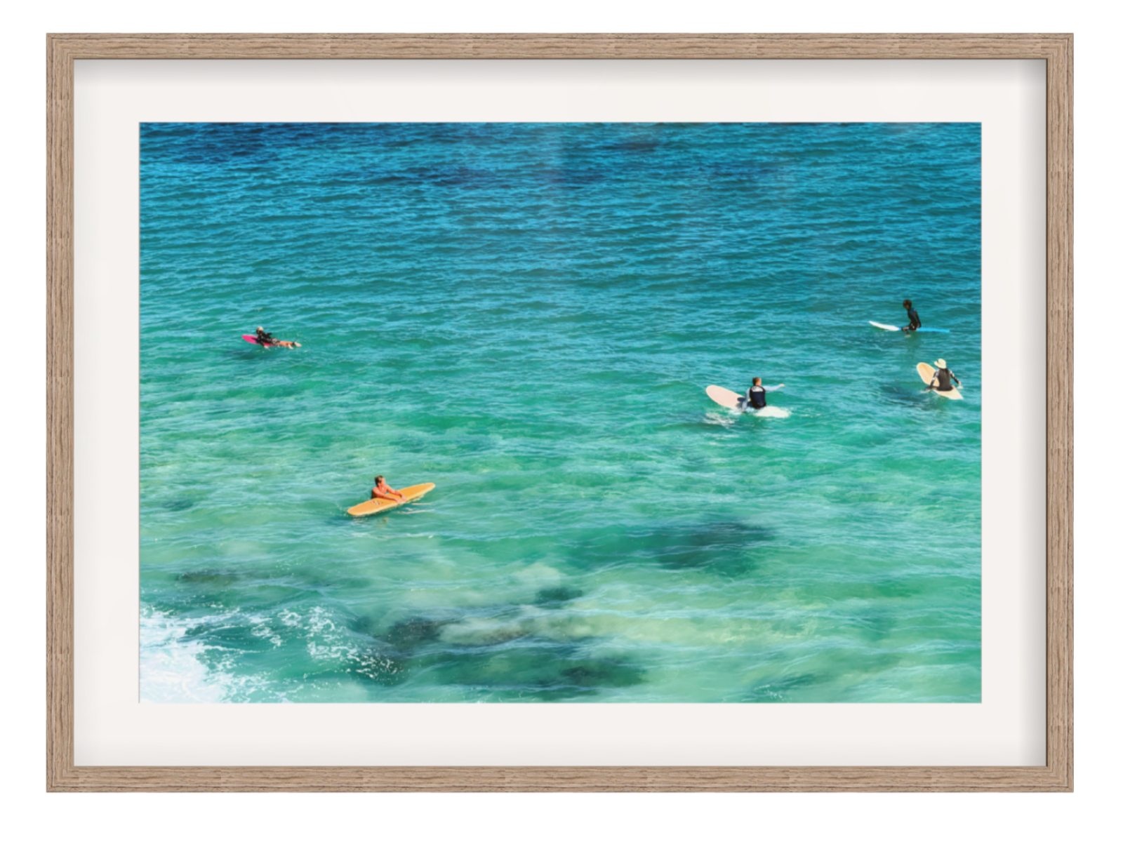 Framed photograph of people kayaking and surfing in clear blue water.
