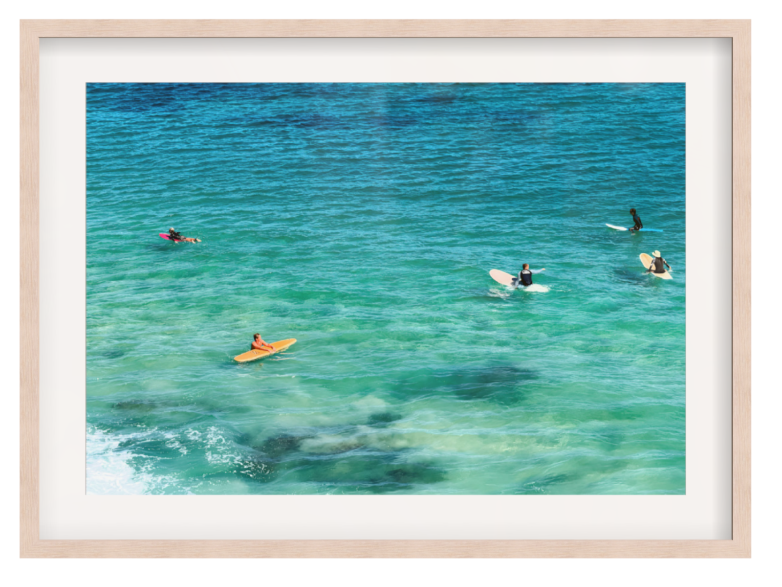 People on surfboards in clear blue water with a beige frame.