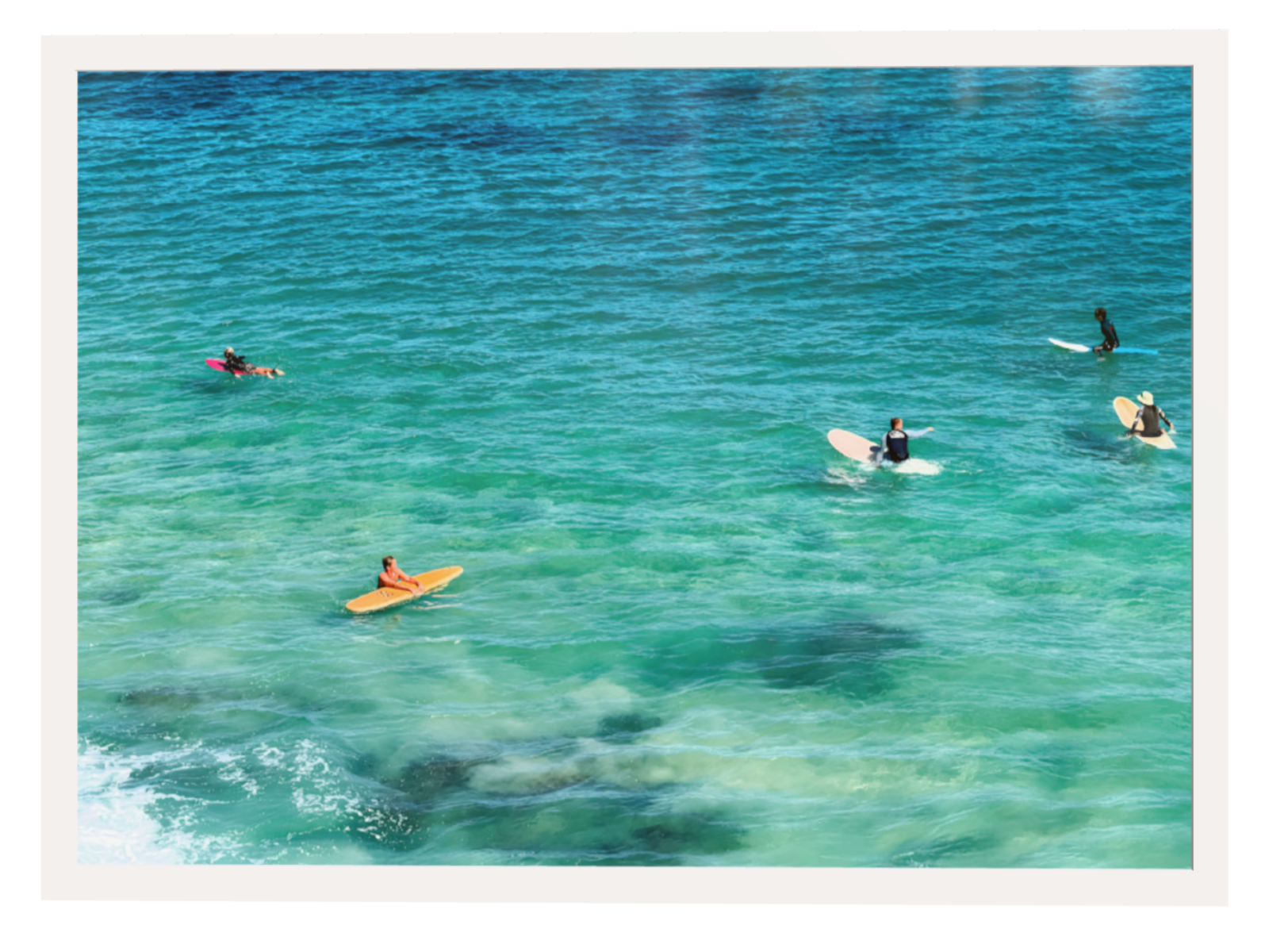 People on surfboards in clear blue water