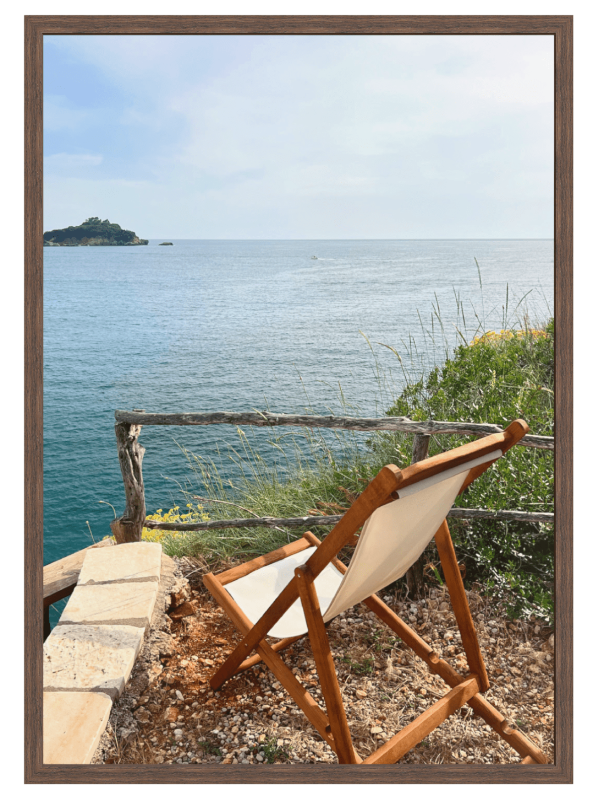 Wooden chair with white cushion overlooking a scenic ocean view with an island.