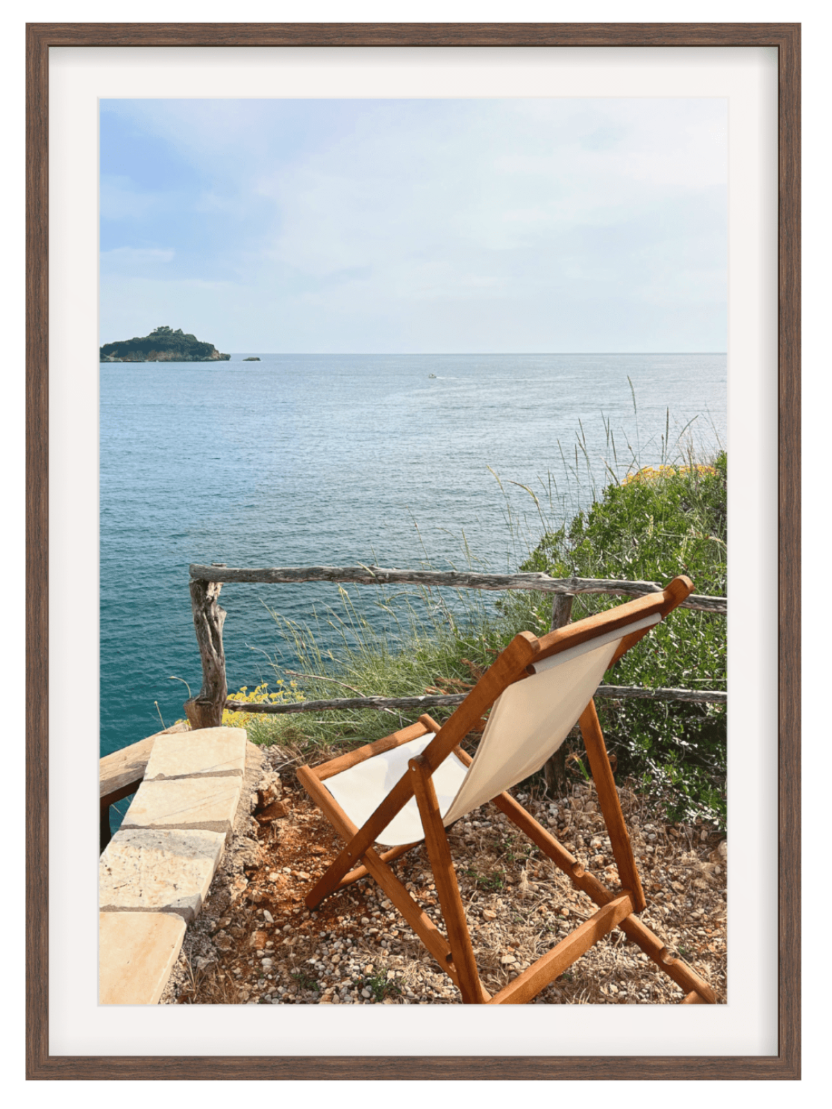 Wooden chair with a view of the ocean and an island in the distance.
