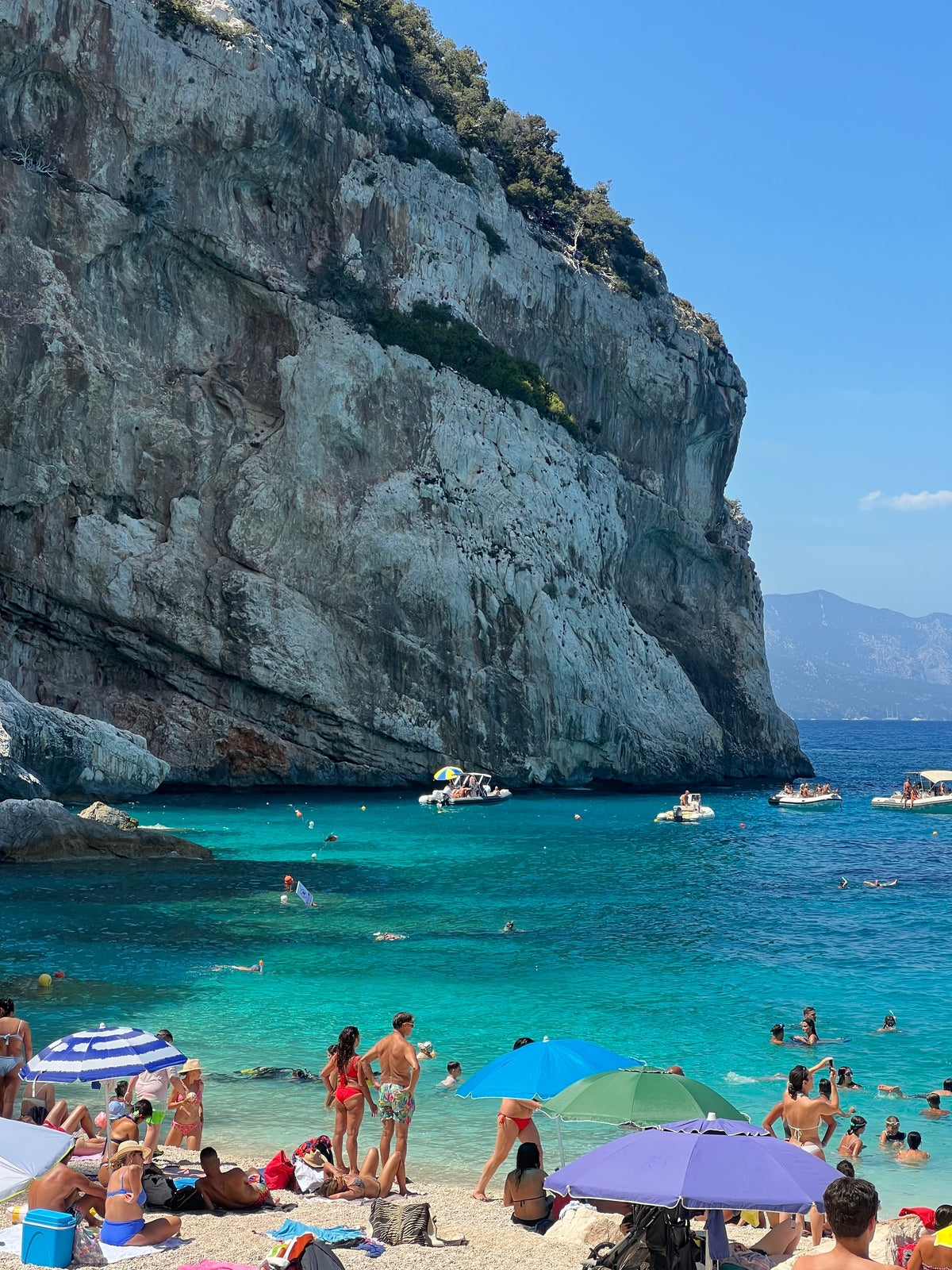 Unframed Cala Mariolu beach print filling full visual area with bright blue sky and massive cliff