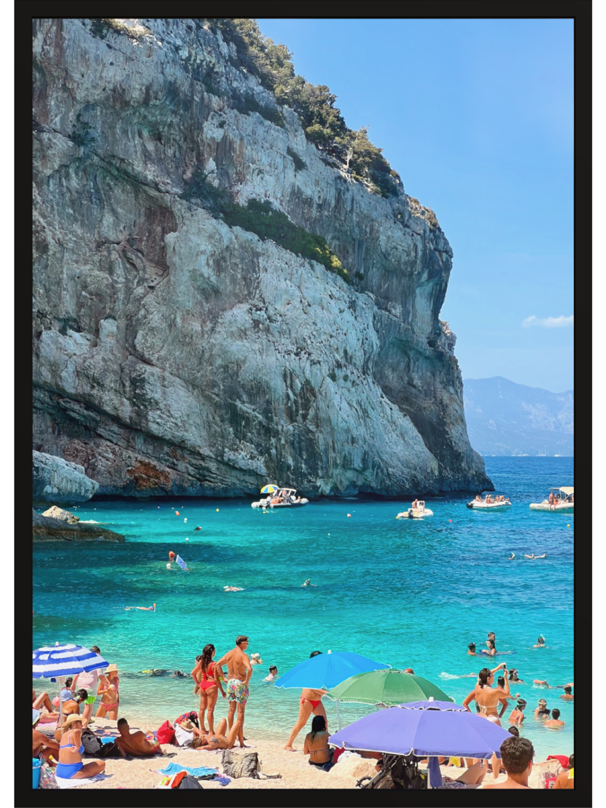 Unframed Sardinia Cala Mariolu print with black border showing turquoise water and beachgoers