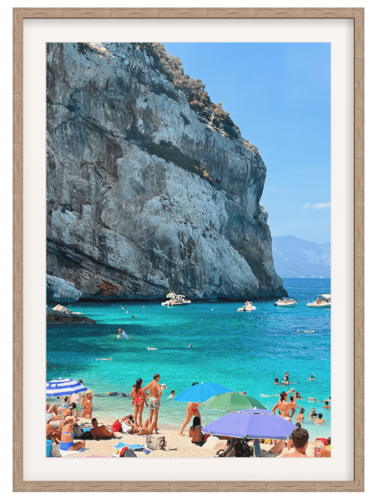 Cala Mariolu beach scene in light wood frame with wide white mat displayed against plain background
