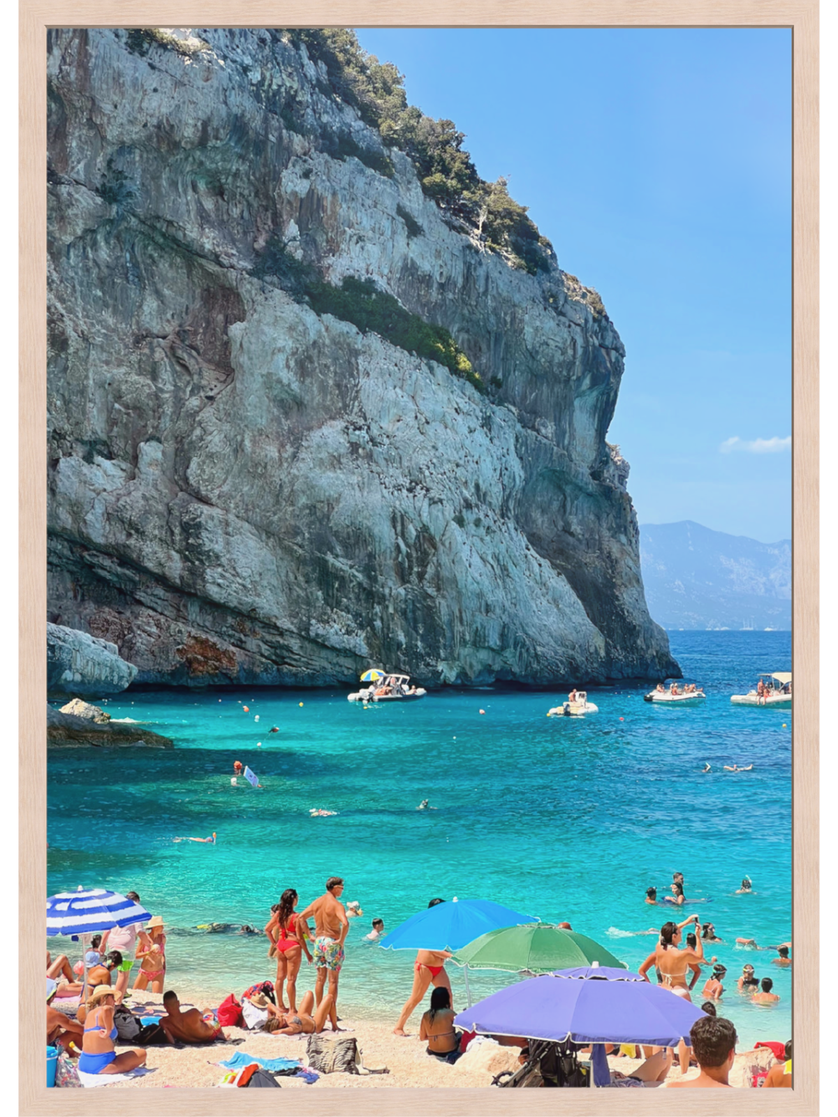 Turquoise sea and limestone cliff wall art in light wood frame highlighting rugged coastline contrast