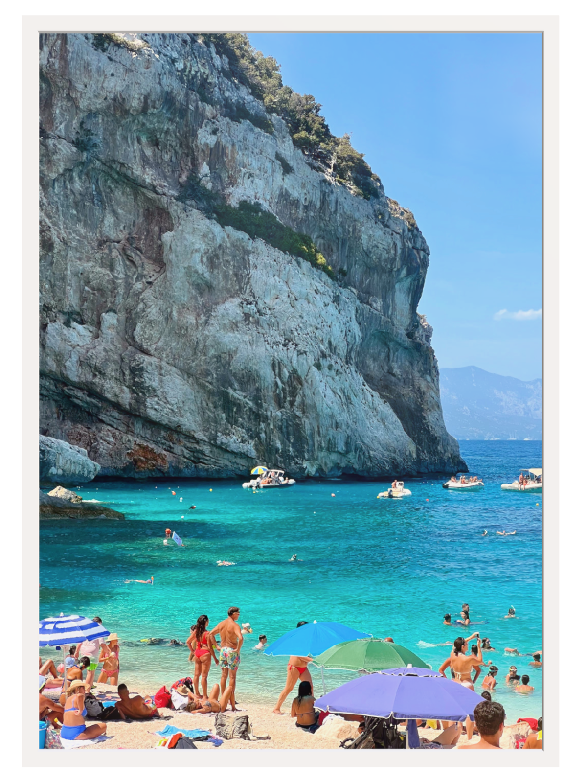 Unframed Cala Mariolu print with thin white border ready for framing showing cliff and boats