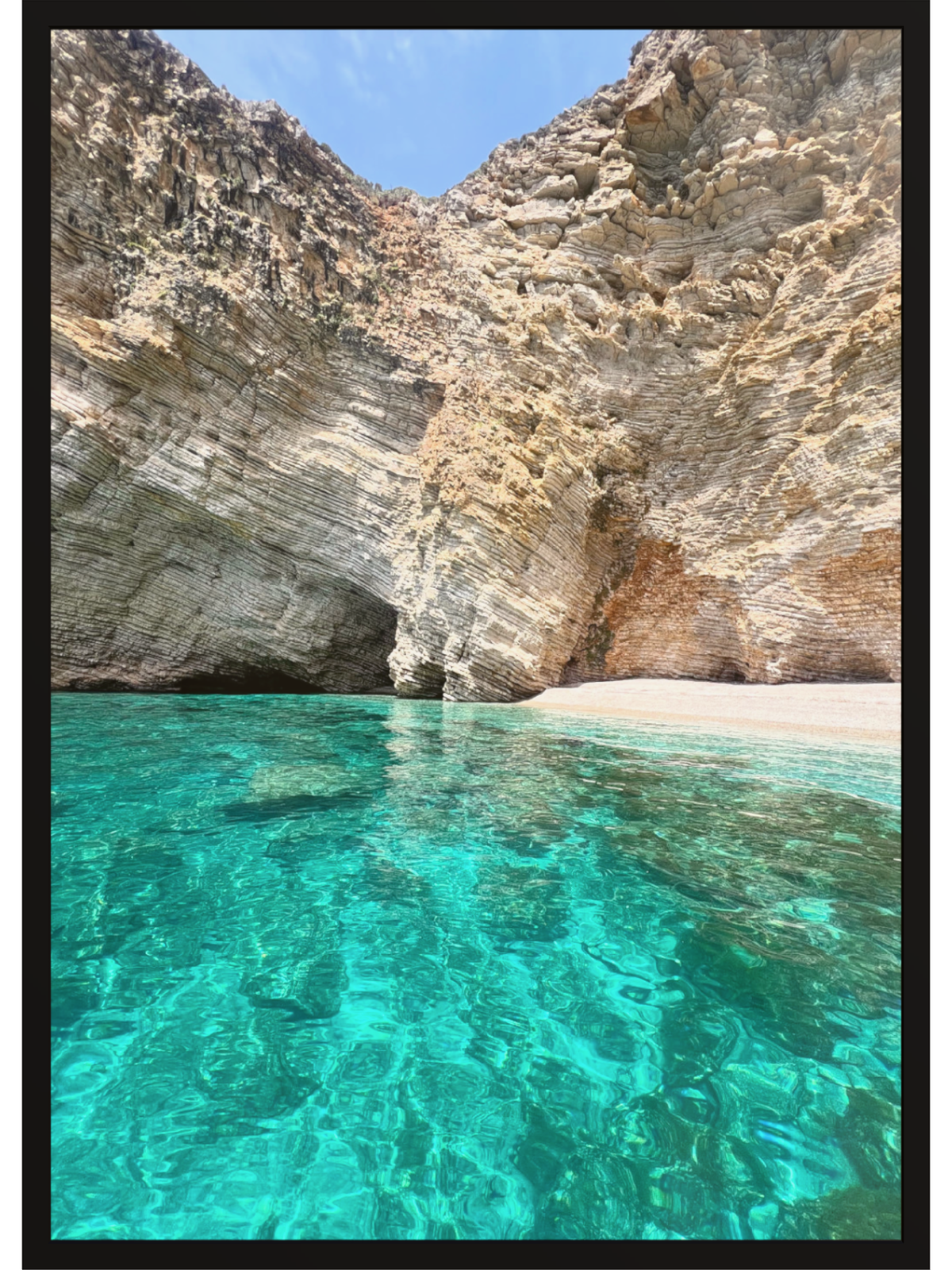 Clear turquoise water and rocky cliffs at a beach