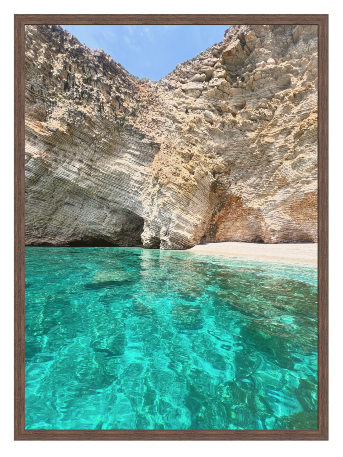 Cave entrance with clear blue water and rocky walls