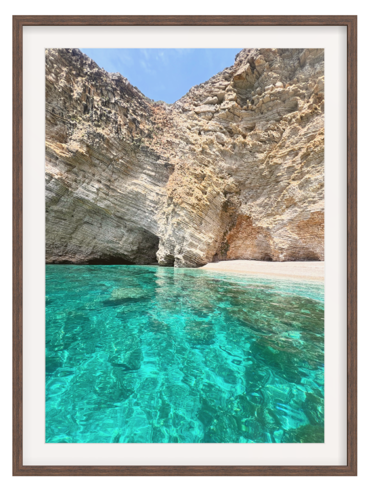 Framed photograph of a rocky coastline with clear blue water