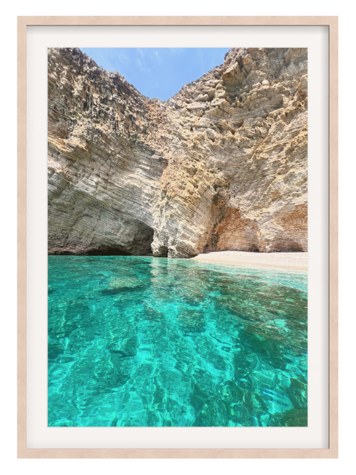 Clear turquoise water with rocky cliffs in the background