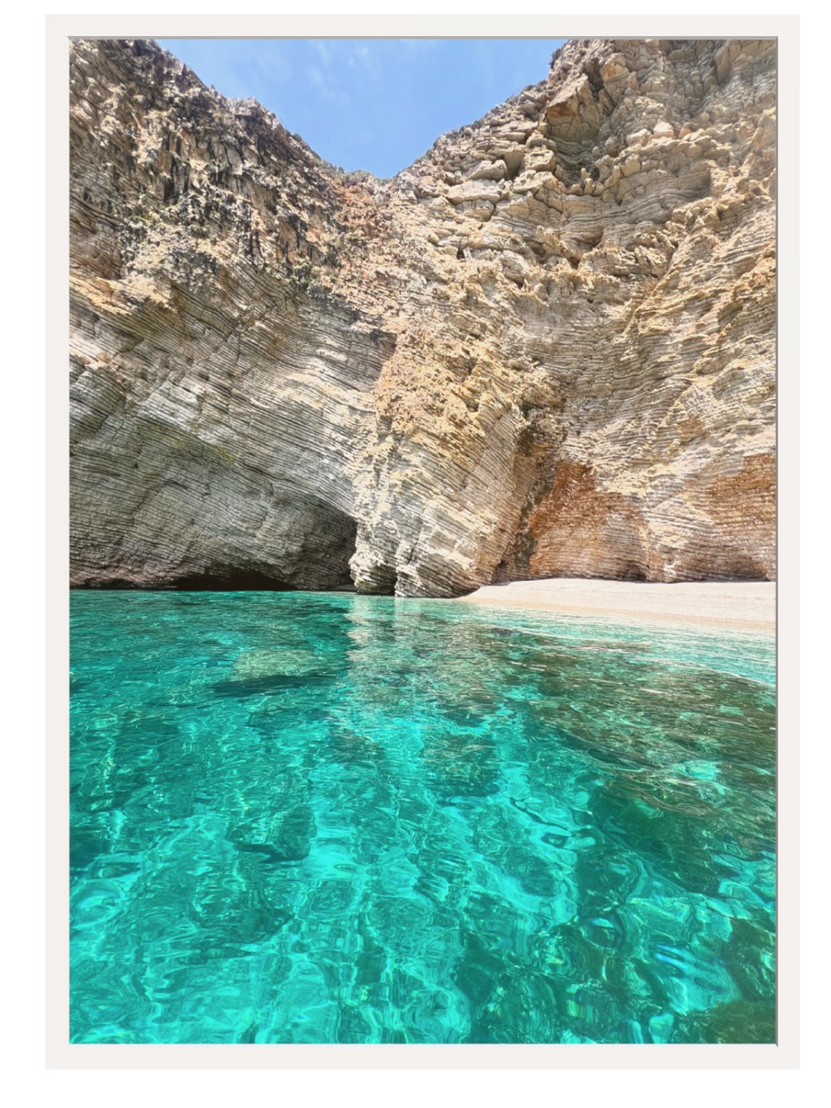 Clear turquoise water and rocky cliffs at a beach