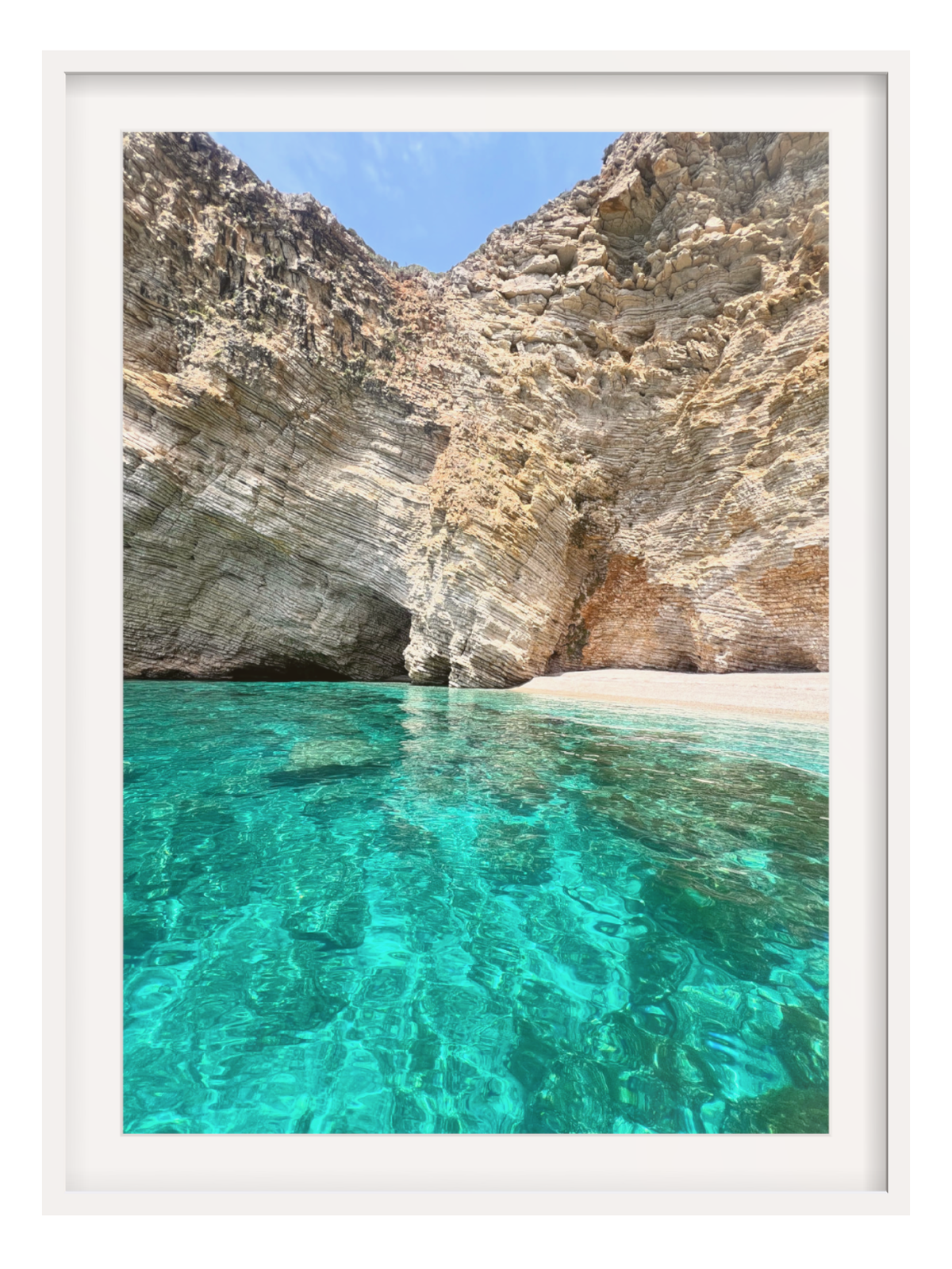 Turquoise water and rocky cliffs with a white frame