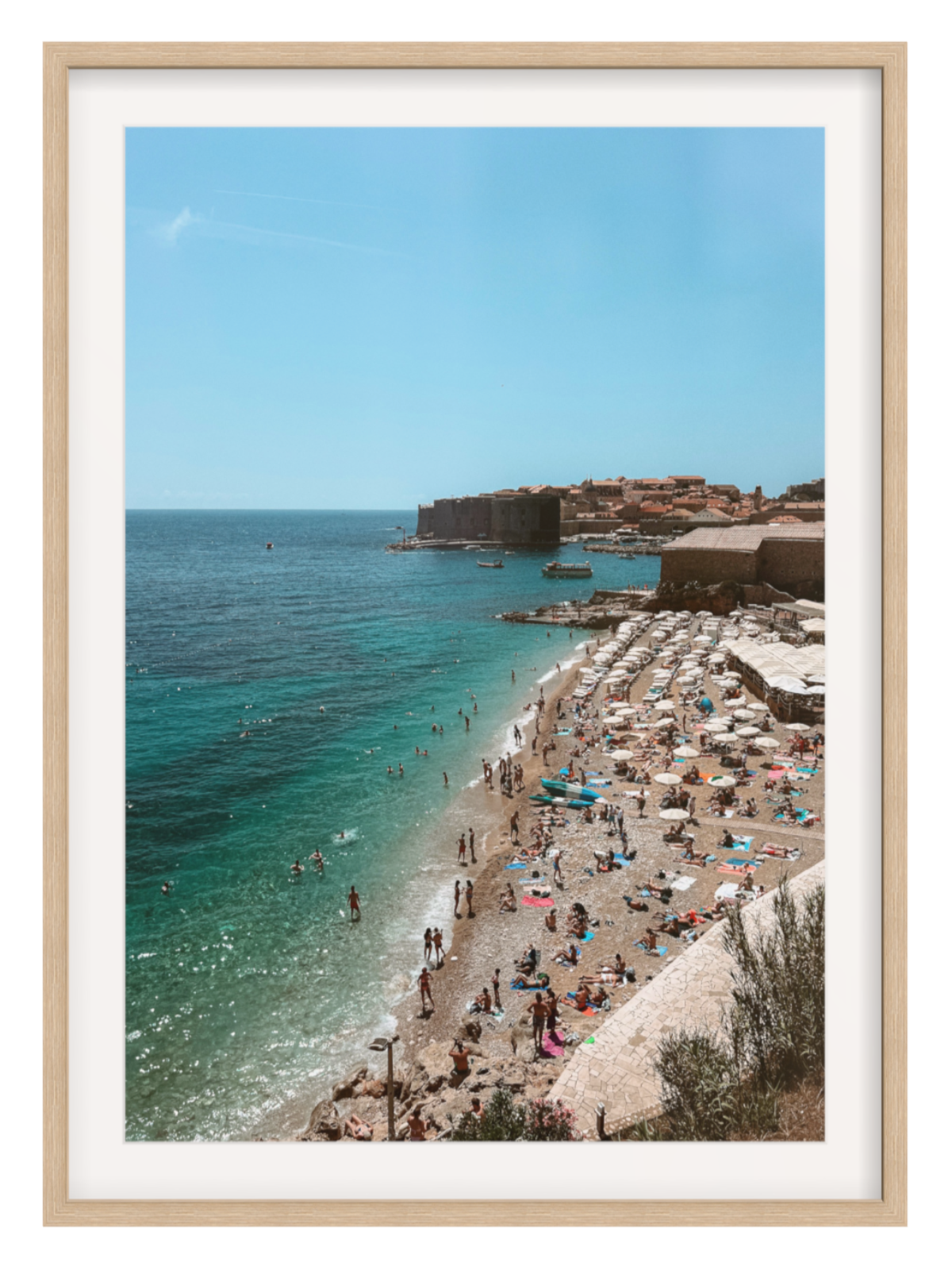 Beach scene with people and umbrellas, framed in a wooden border
