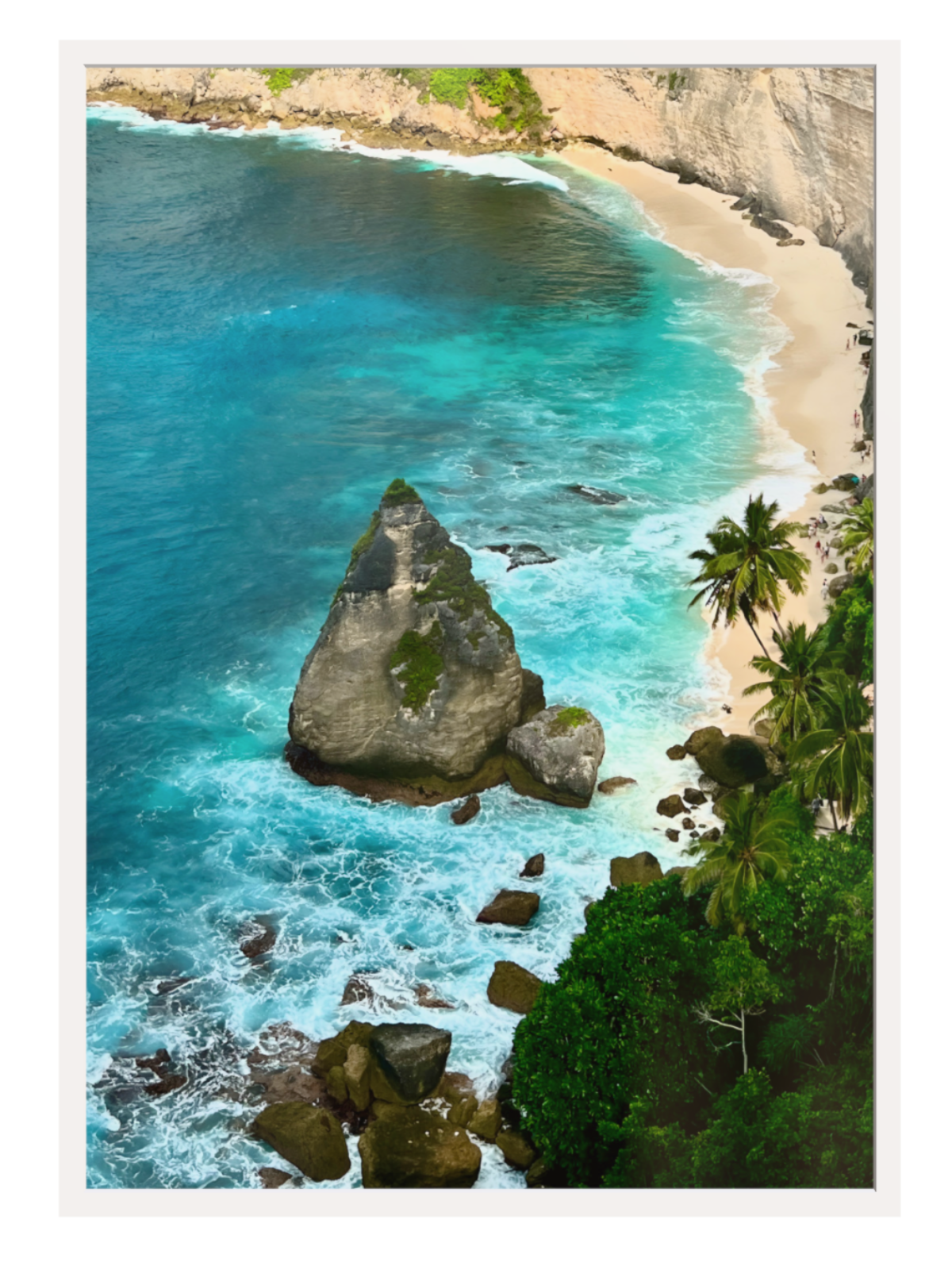 White frame Aerial view of a tropical beach with turquoise waters, rocks, and palm trees.