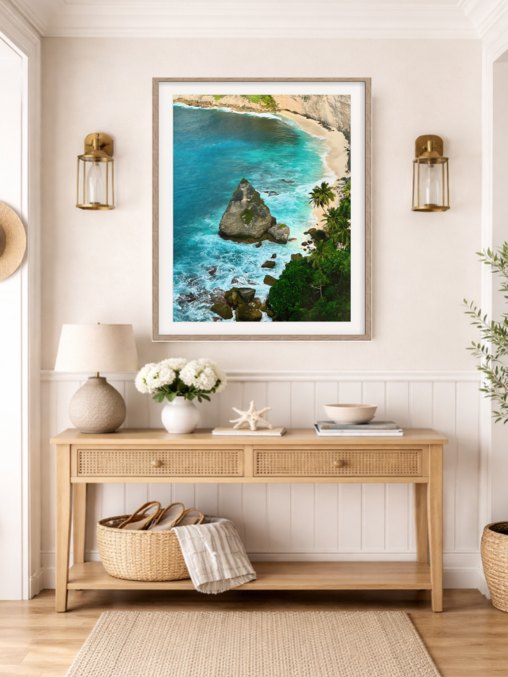 Nautical-themed room with a framed beach scene, wooden console table, and decorative items.