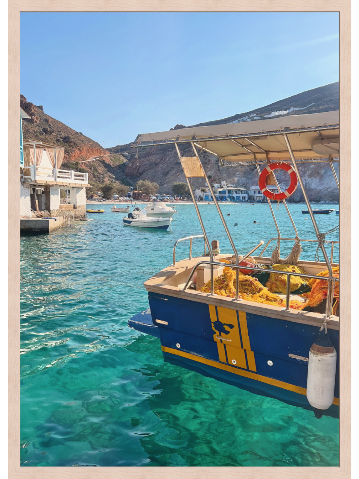 Boat in clear blue water with a scenic background