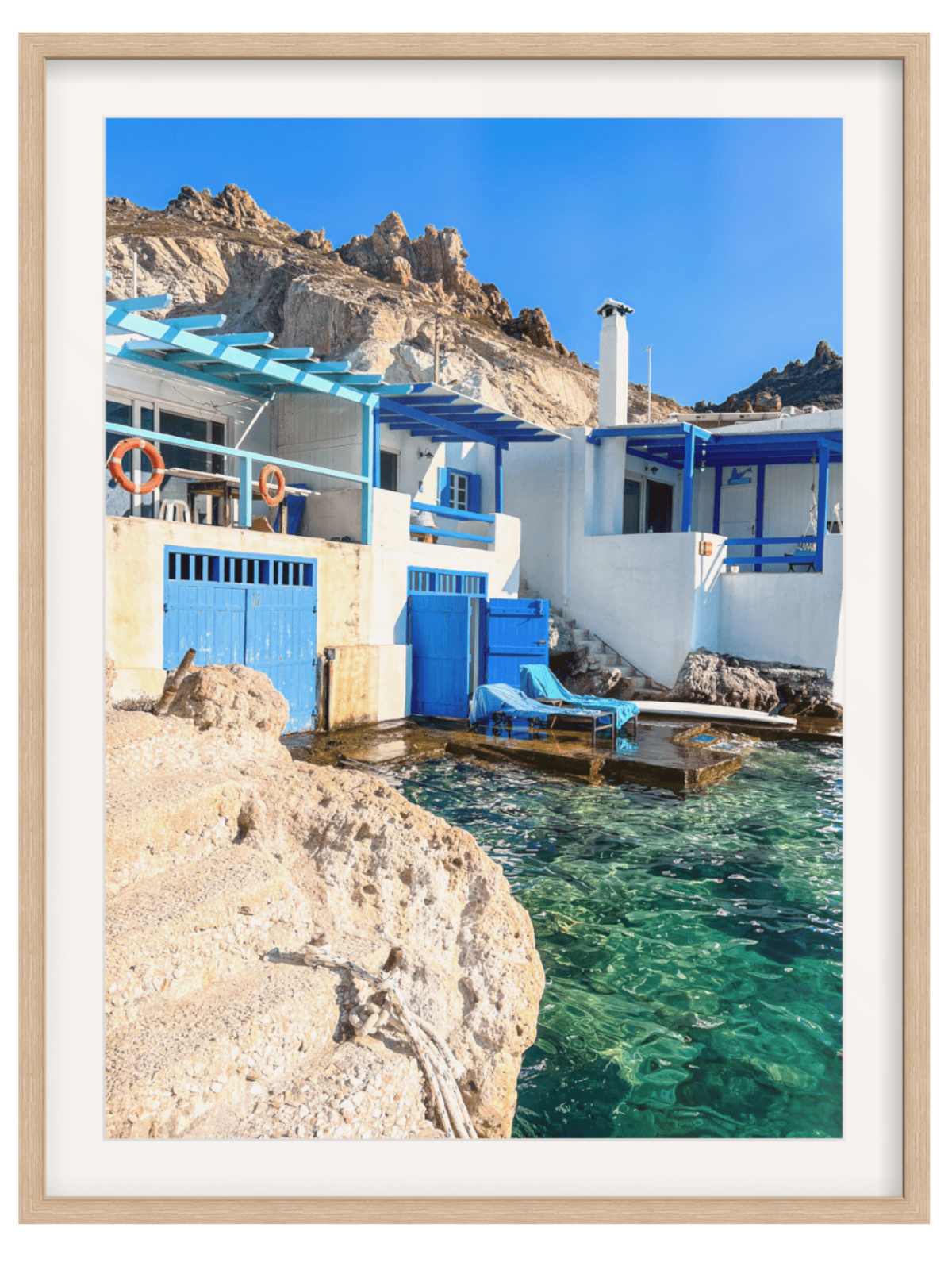 Firopotamos Greece print in light wood frame featuring white buildings and blue accents