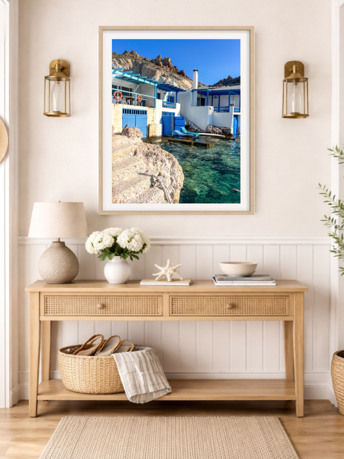 Greek island wall art hanging above console table showing Firopotamos village scene