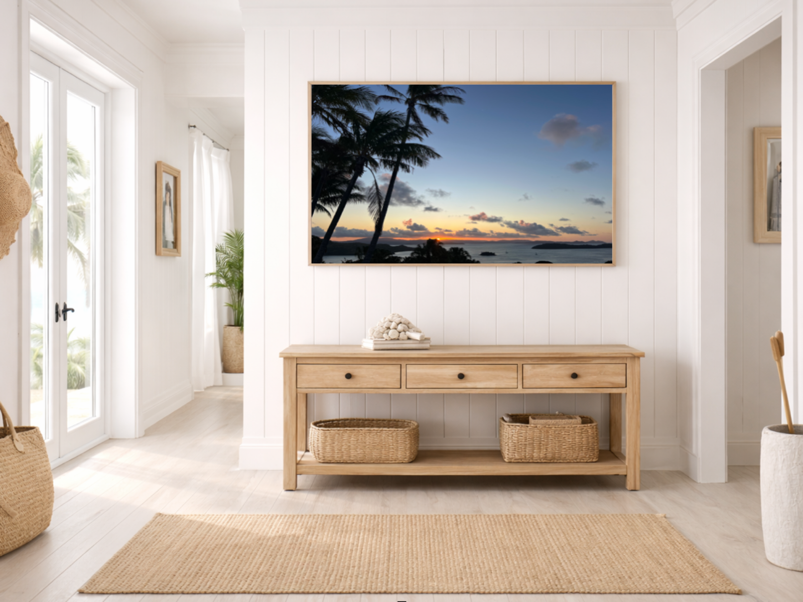 Modern interior with wooden console table, decorative items, and a tropical beach painting.