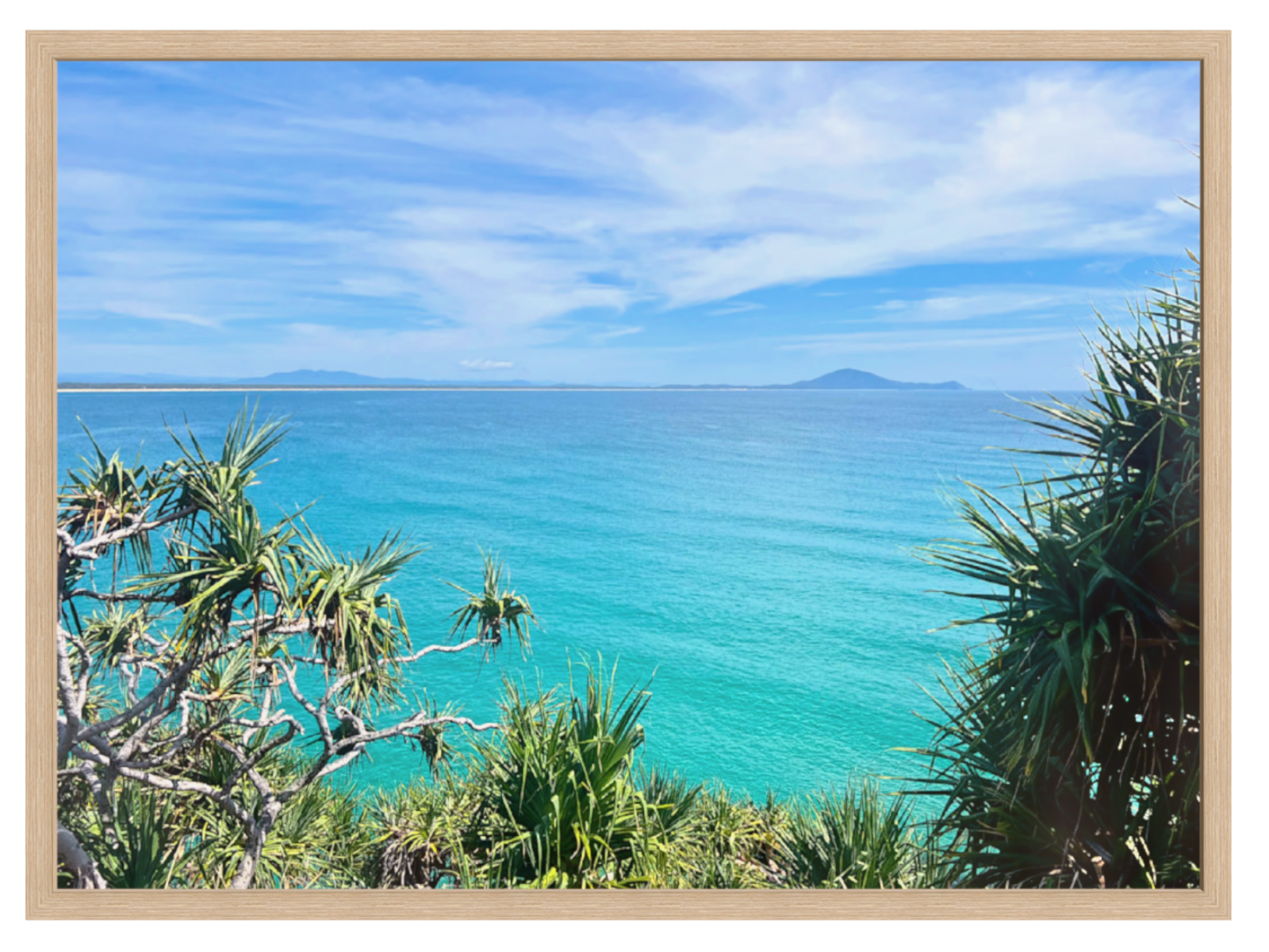 Scenic view of a tropical beach with turquoise water and clear blue sky.