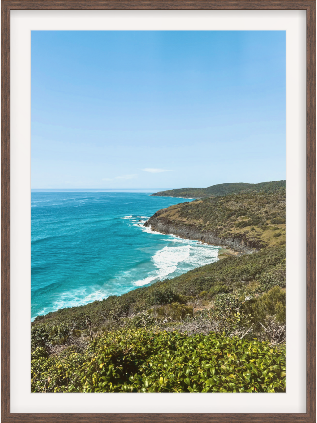 Hat Head Australia coastal scene in dark wood frame with white mat featuring white-capped waves and cliffs a