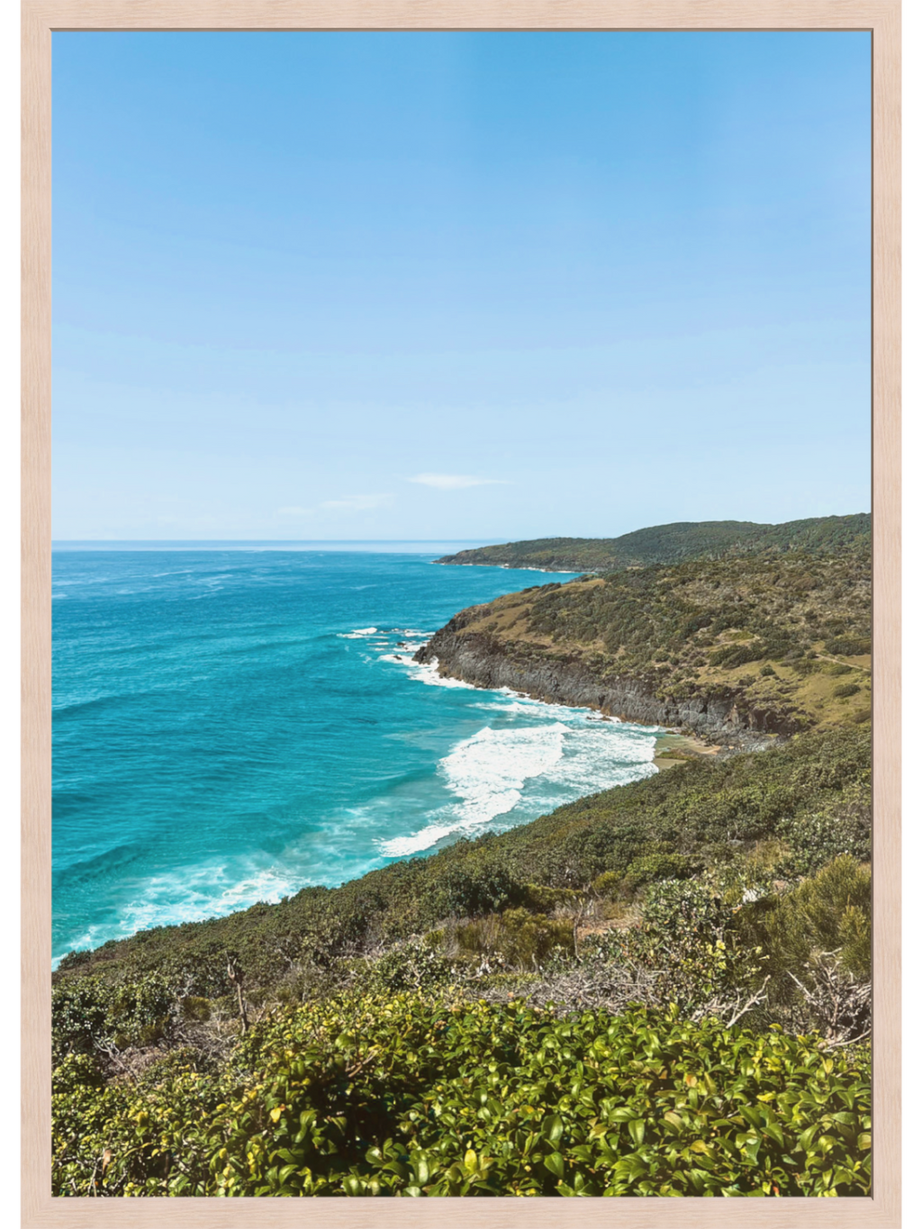 Hat Head Australia coastal wall art print in light wood frame with turquoise ocean and green headland