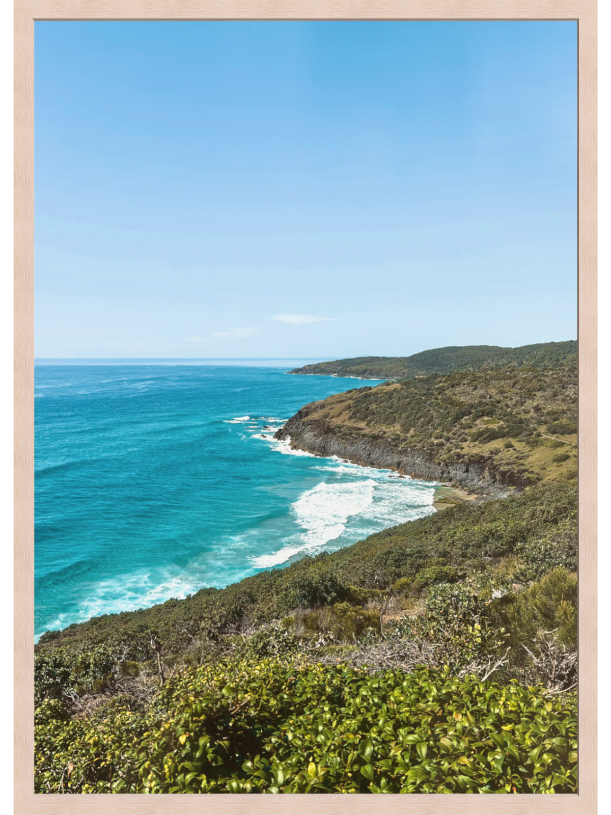 Hat Head Australia coastal wall art print in light wood frame with turquoise ocean and green headland