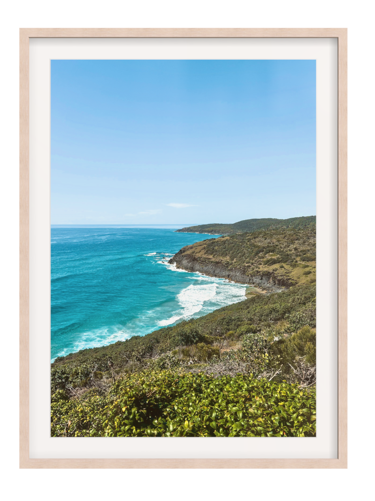 Hat Head Australia wall art in natural wood frame with wide white mat capturing turquoise sea and green cliffs