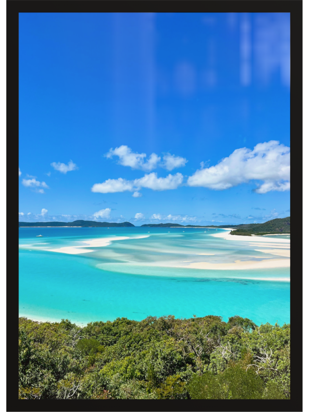 Turquoise waters and white sand beach with blue sky and clouds