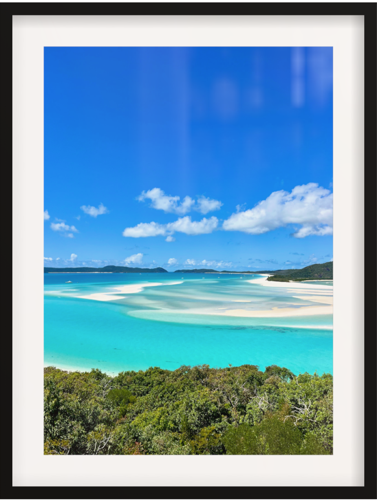 Scenic view of a tropical island with clear blue water and white sand.
