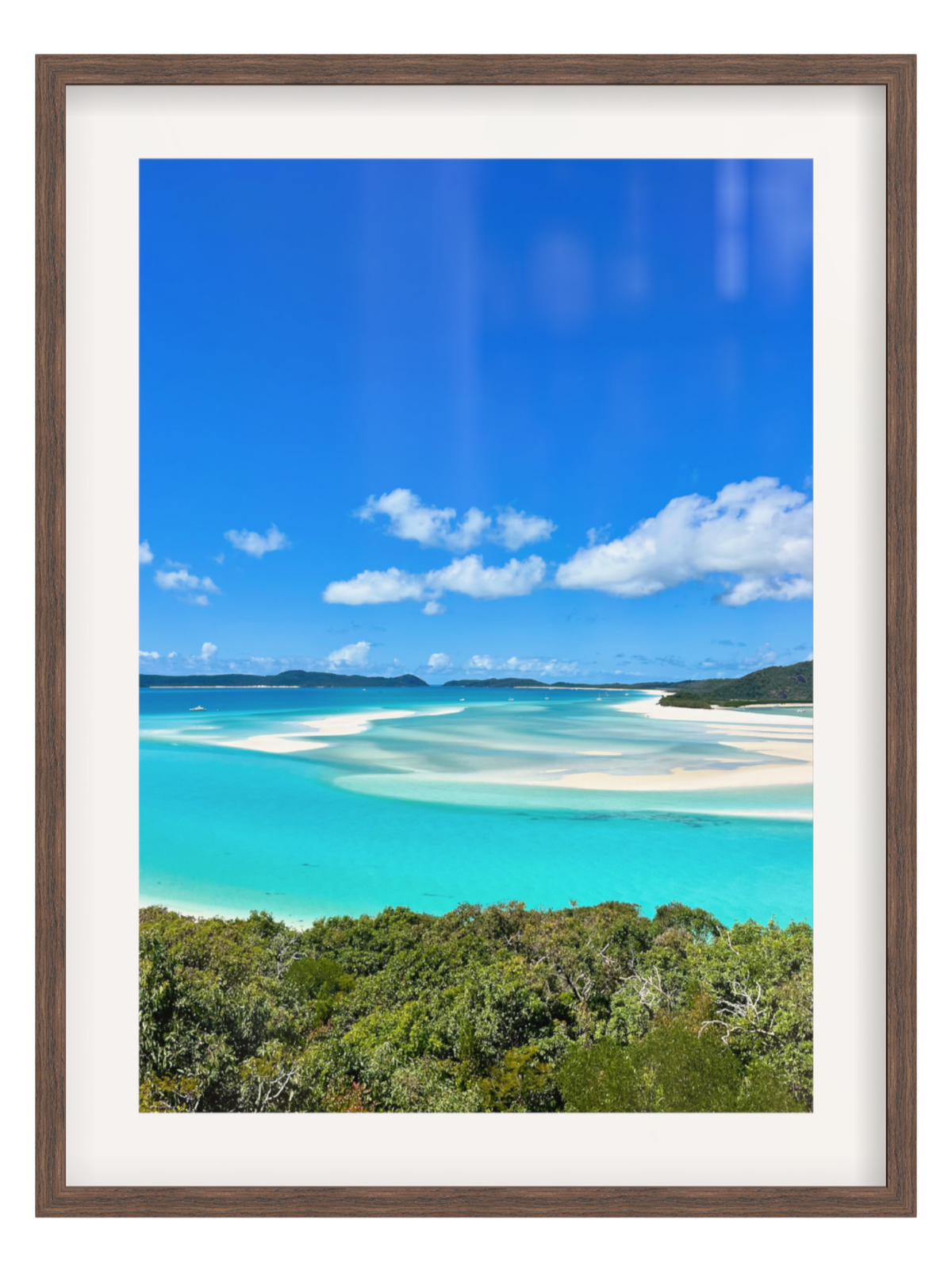 Framed photograph of a tropical beach with turquoise water and blue sky.