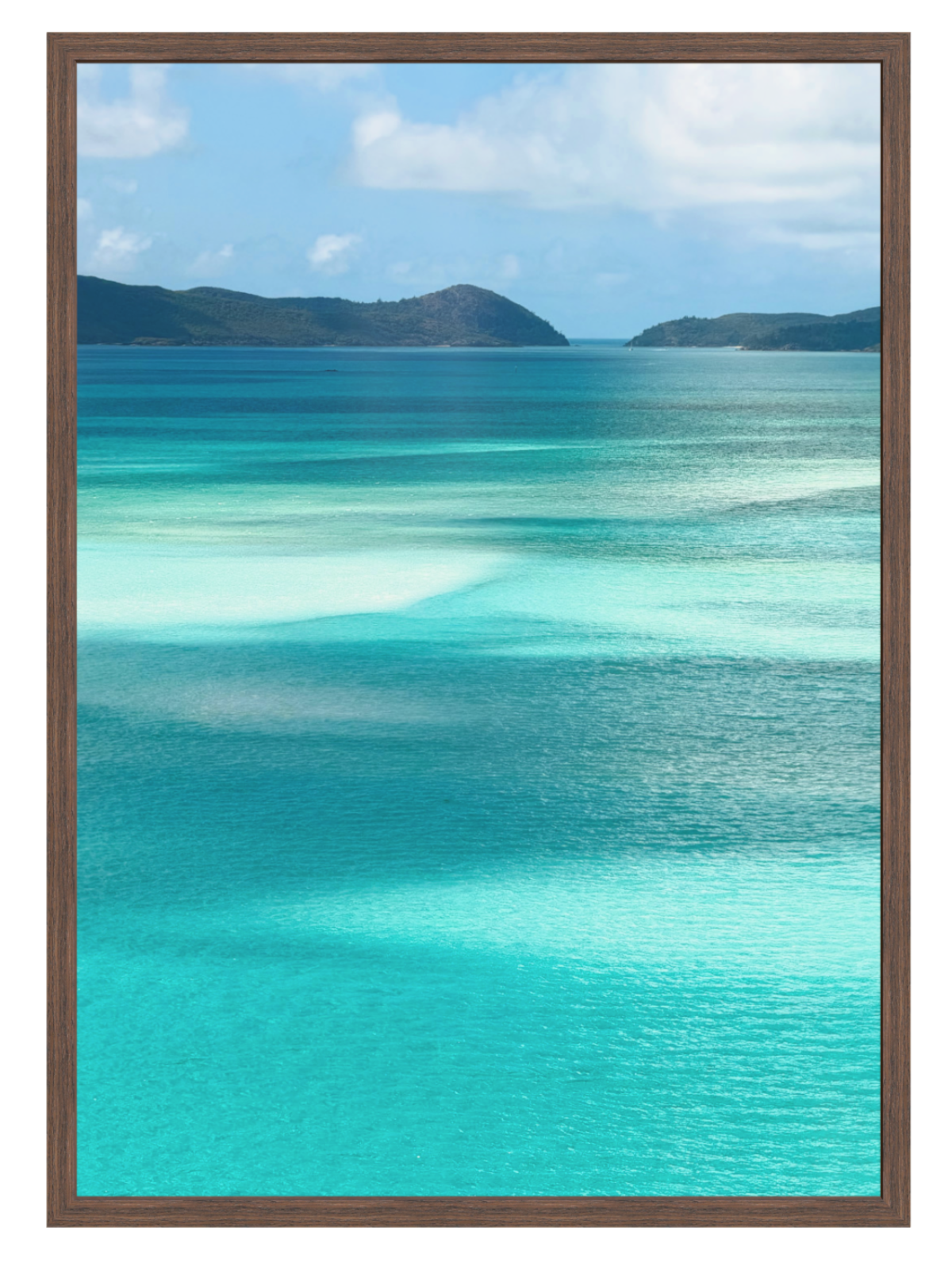 Scenic view of turquoise ocean water with shallow clear pools, distant dark green hills, and a blue sky with white clouds. choc frame