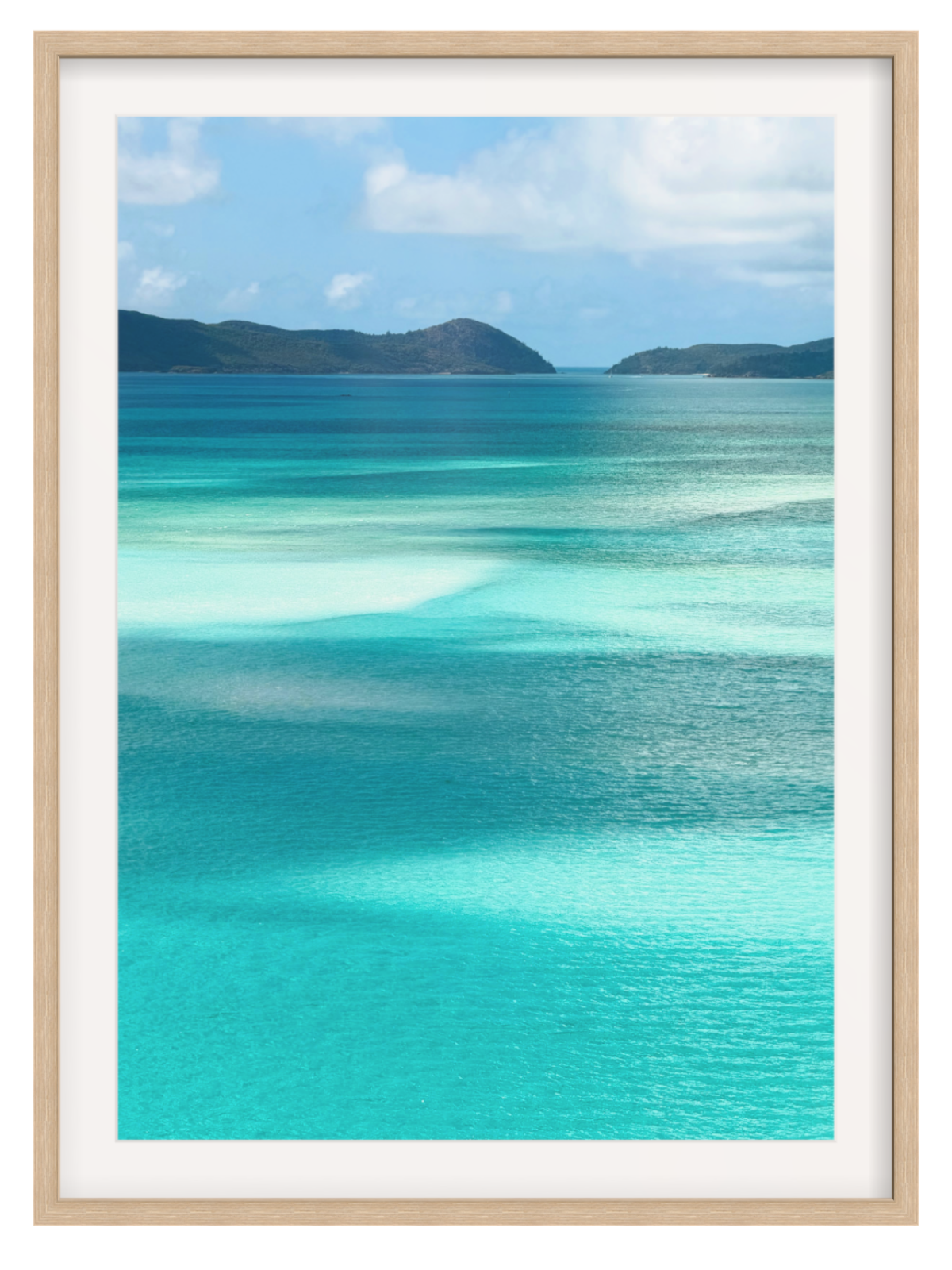 Scenic view of turquoise ocean water with shallow clear pools, distant dark green hills, and a blue sky with white clouds.oak frame