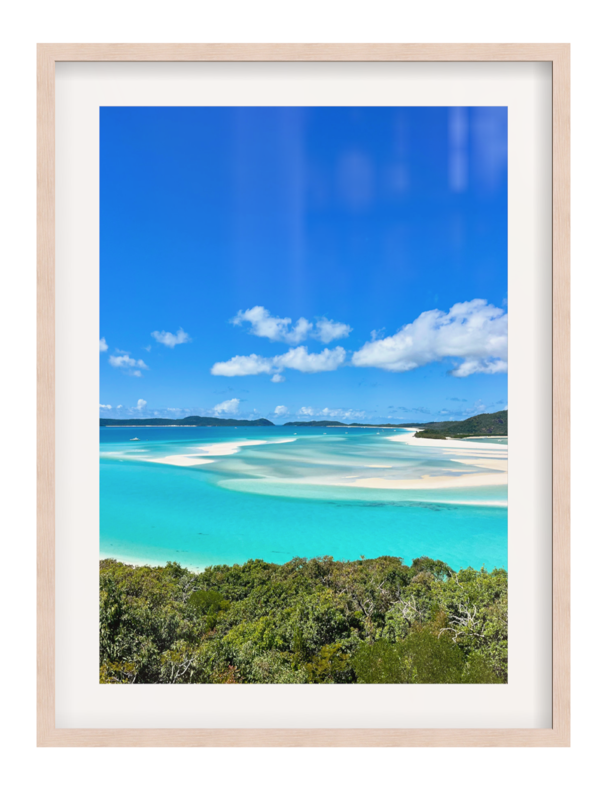 Framed photograph of a tropical beach with clear blue water and sky.