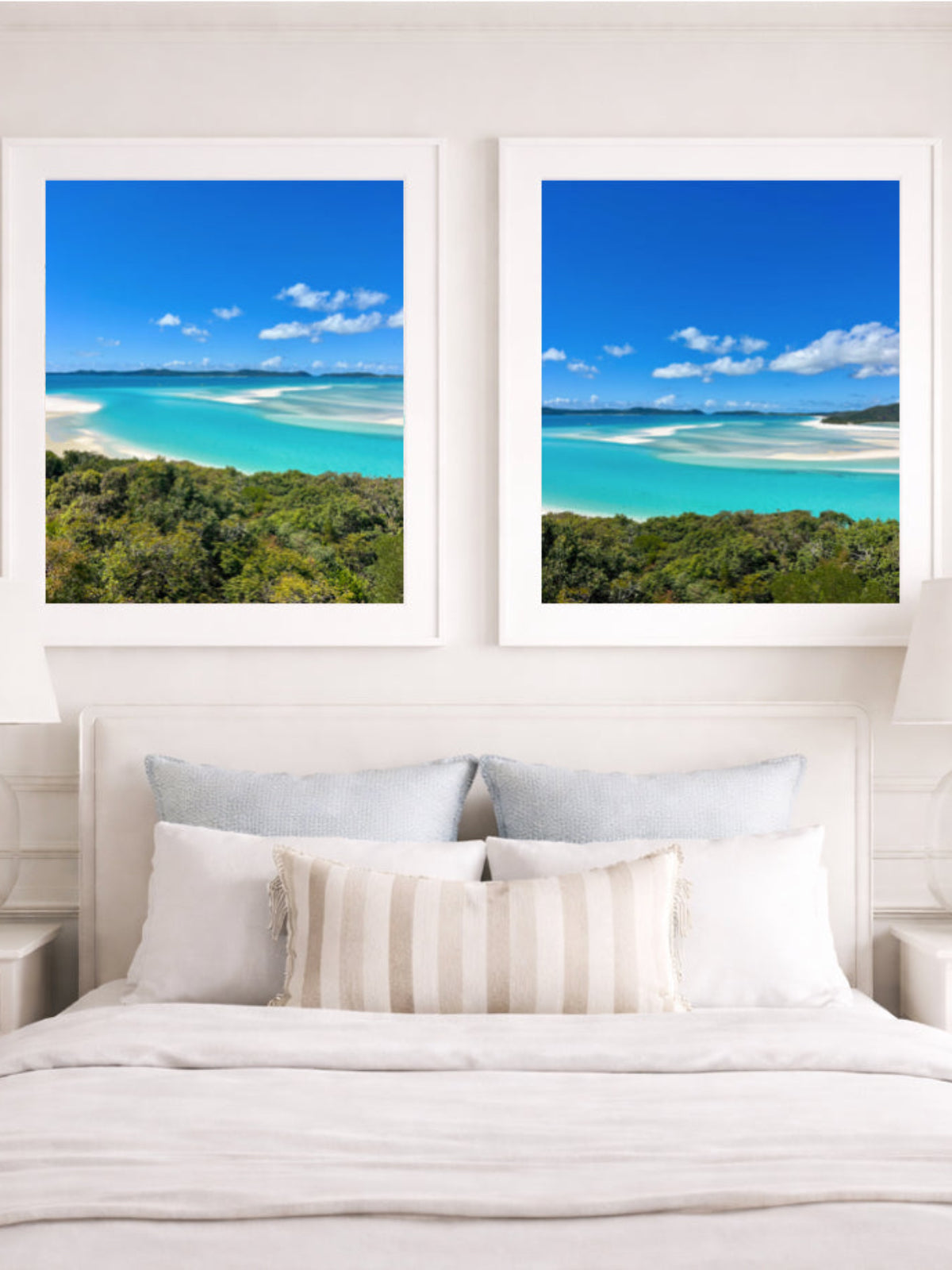 Two framed beach scenes above a bed in a bedroom setting.