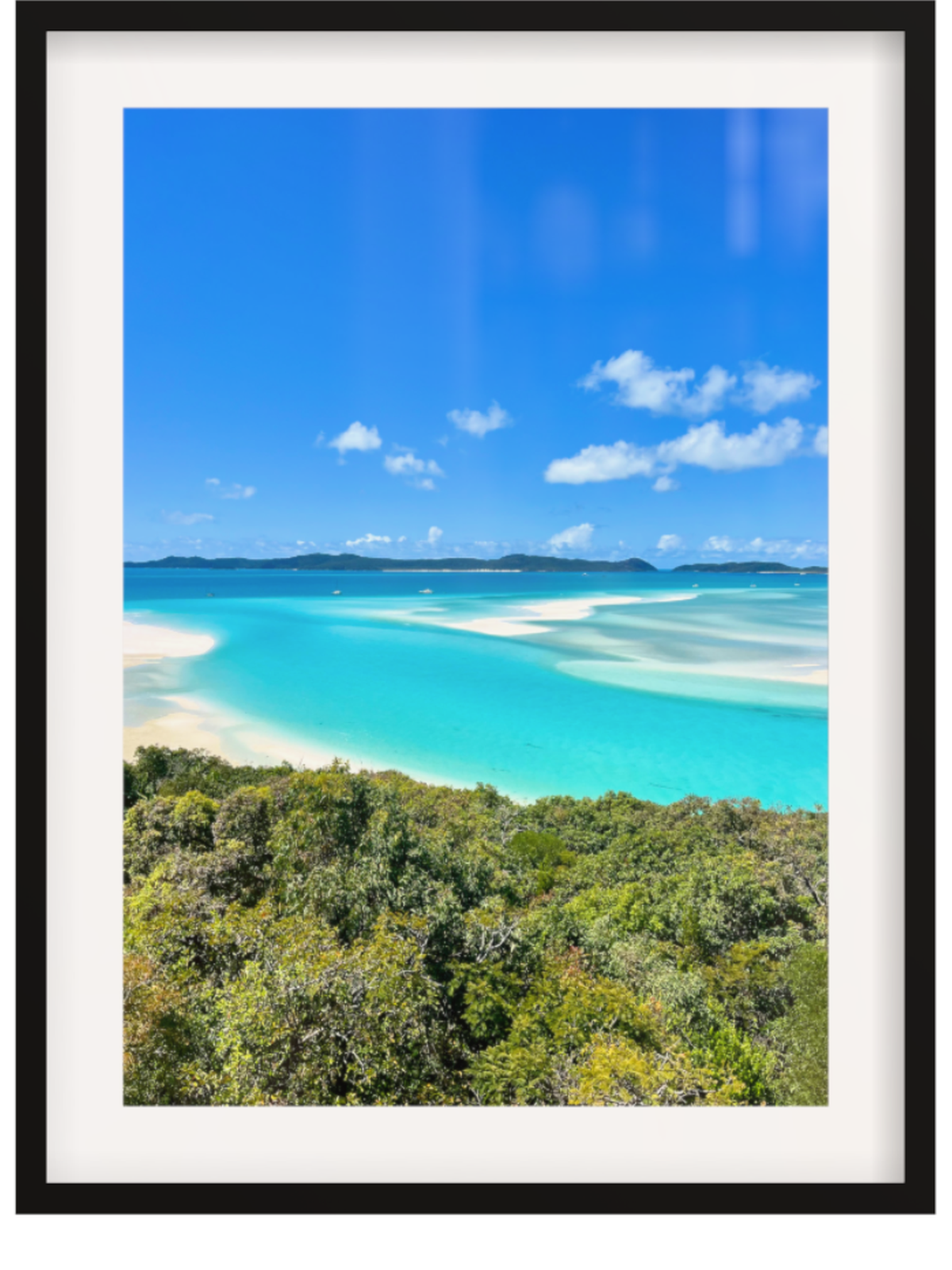 Framed photograph of a tropical beach with clear blue water and white sand.